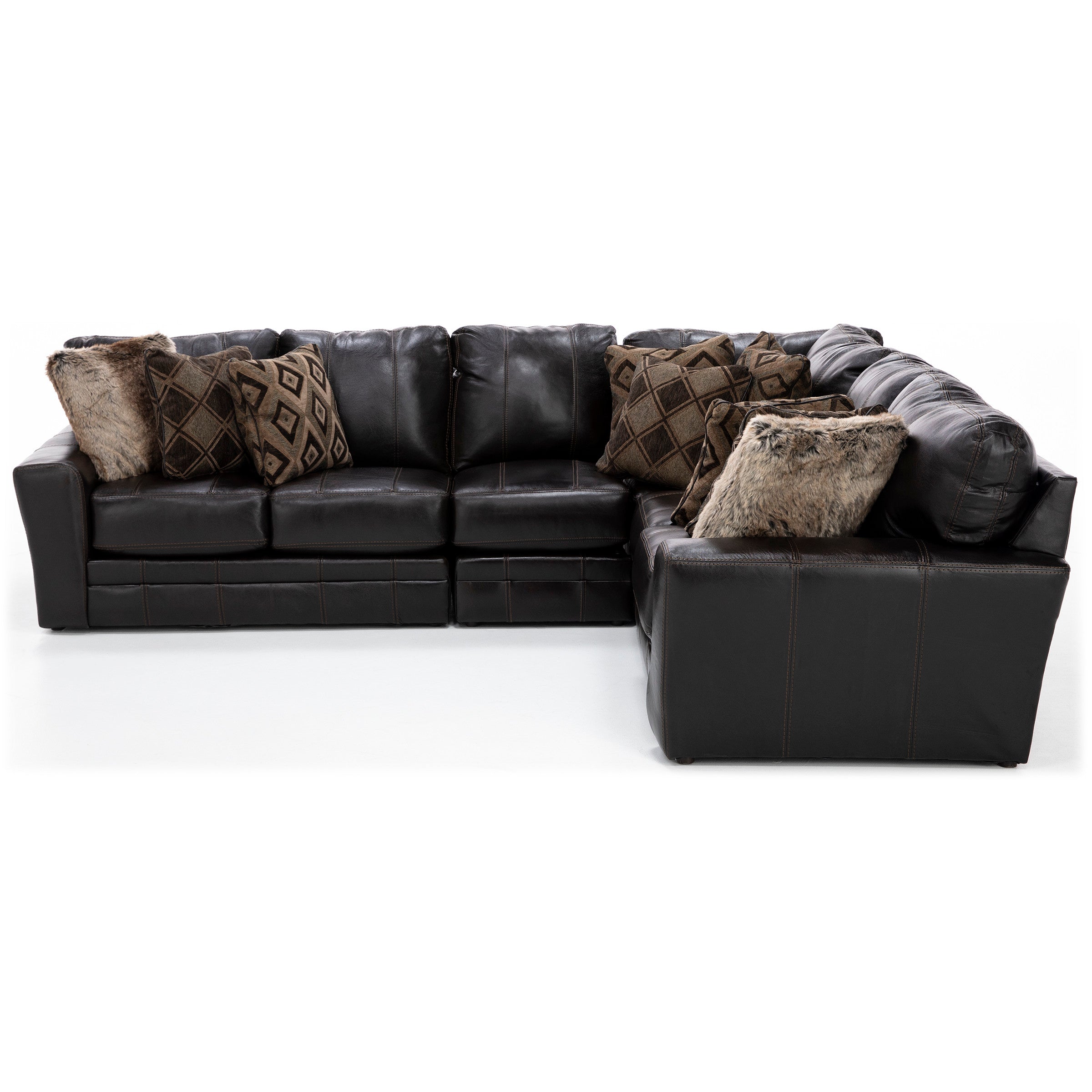Dark brown leather sectional sofa with patterned and faux fur pillows.