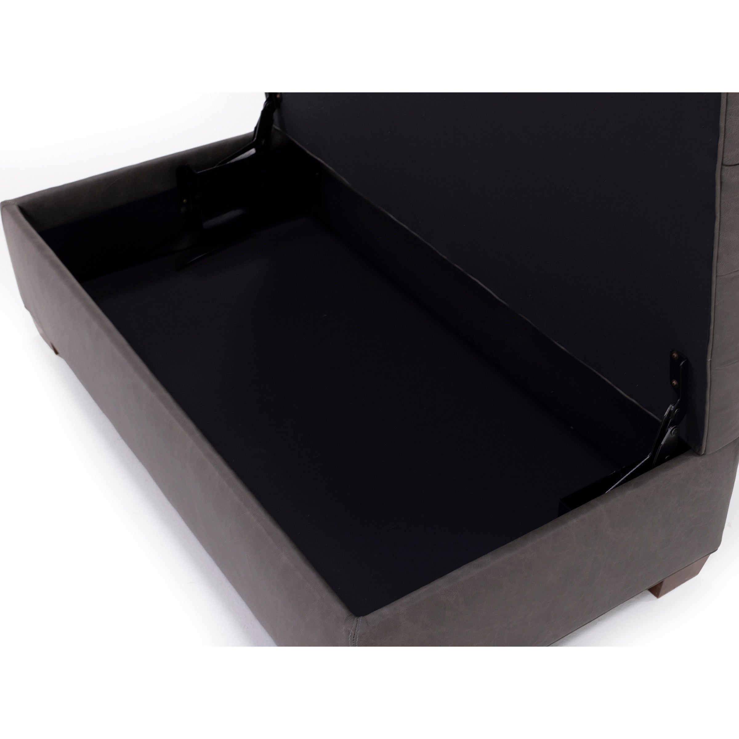 Open storage compartment inside a sofa base.
