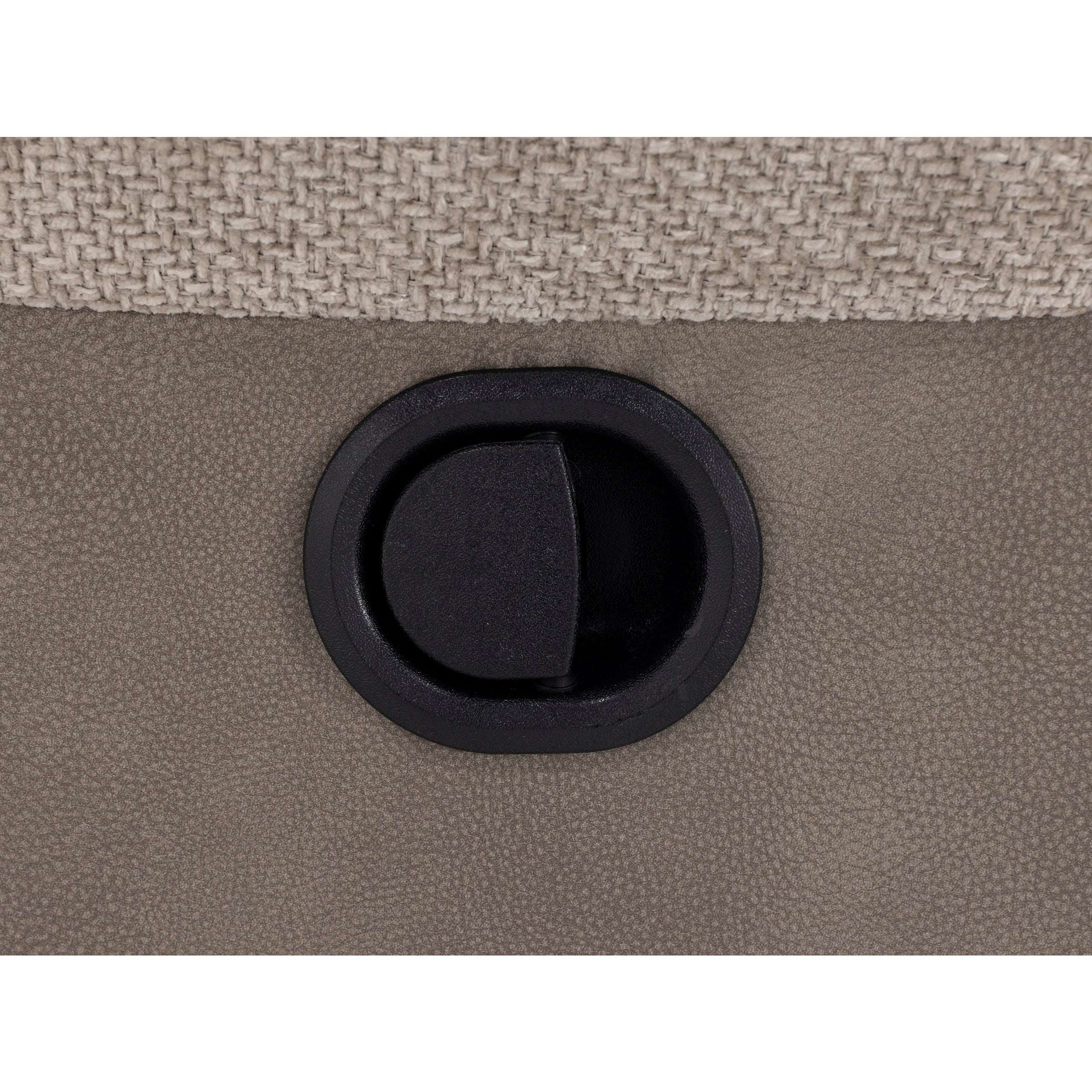 Close-up of a recliner lever against a textured fabric and leather background.
