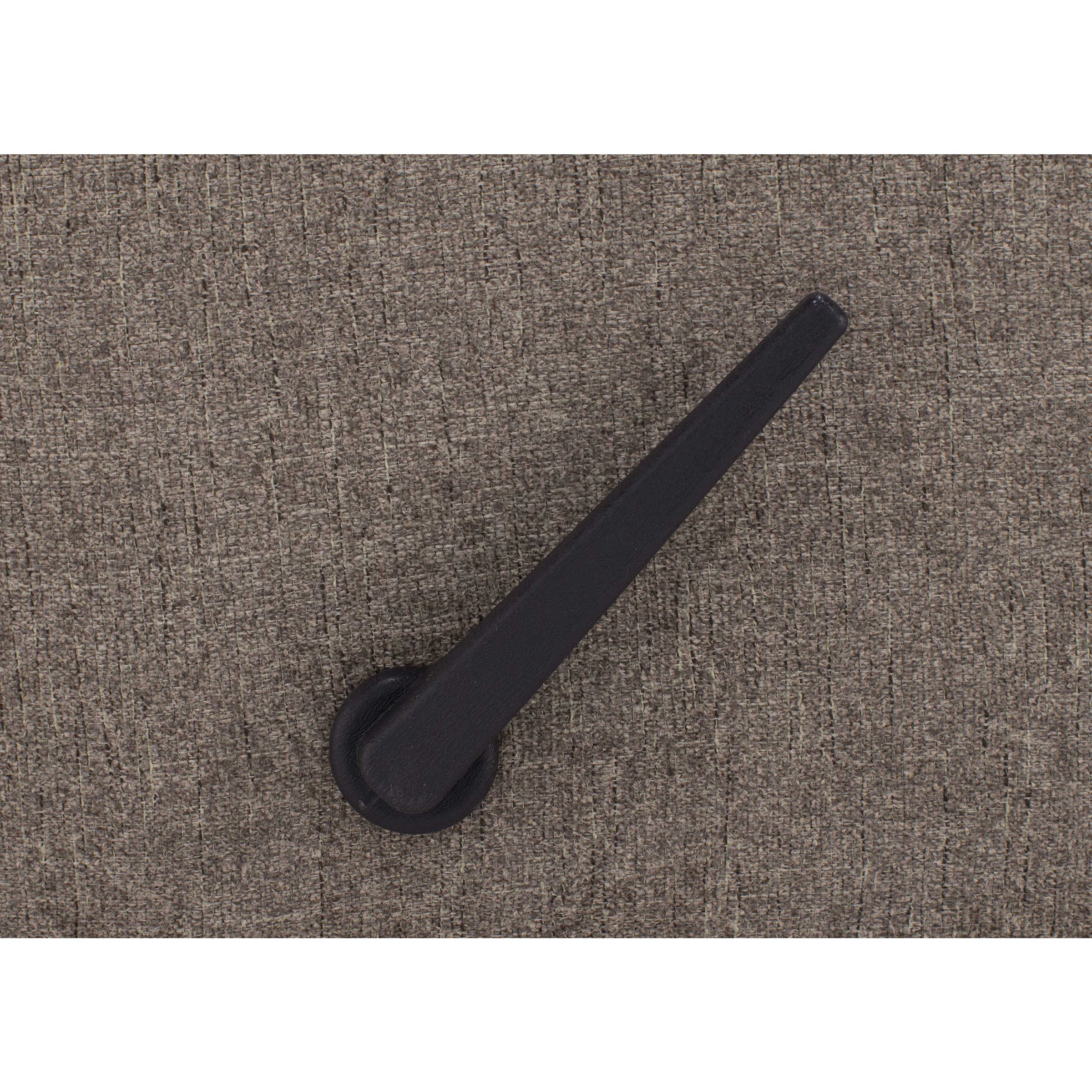 Black lever handle on textured brown upholstery.