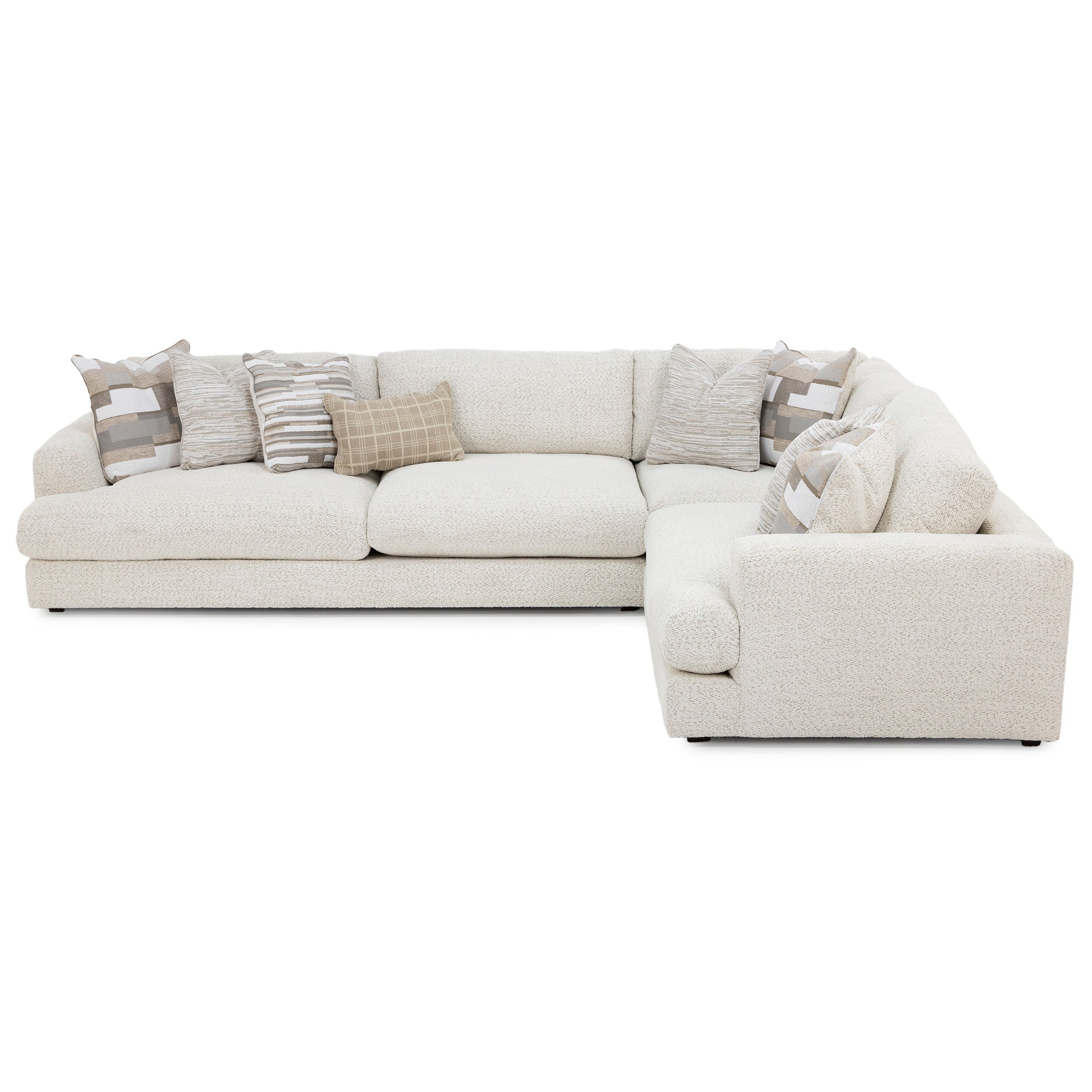 Ivory L-shaped sectional sofa with textured upholstery and decorative accent pillows.