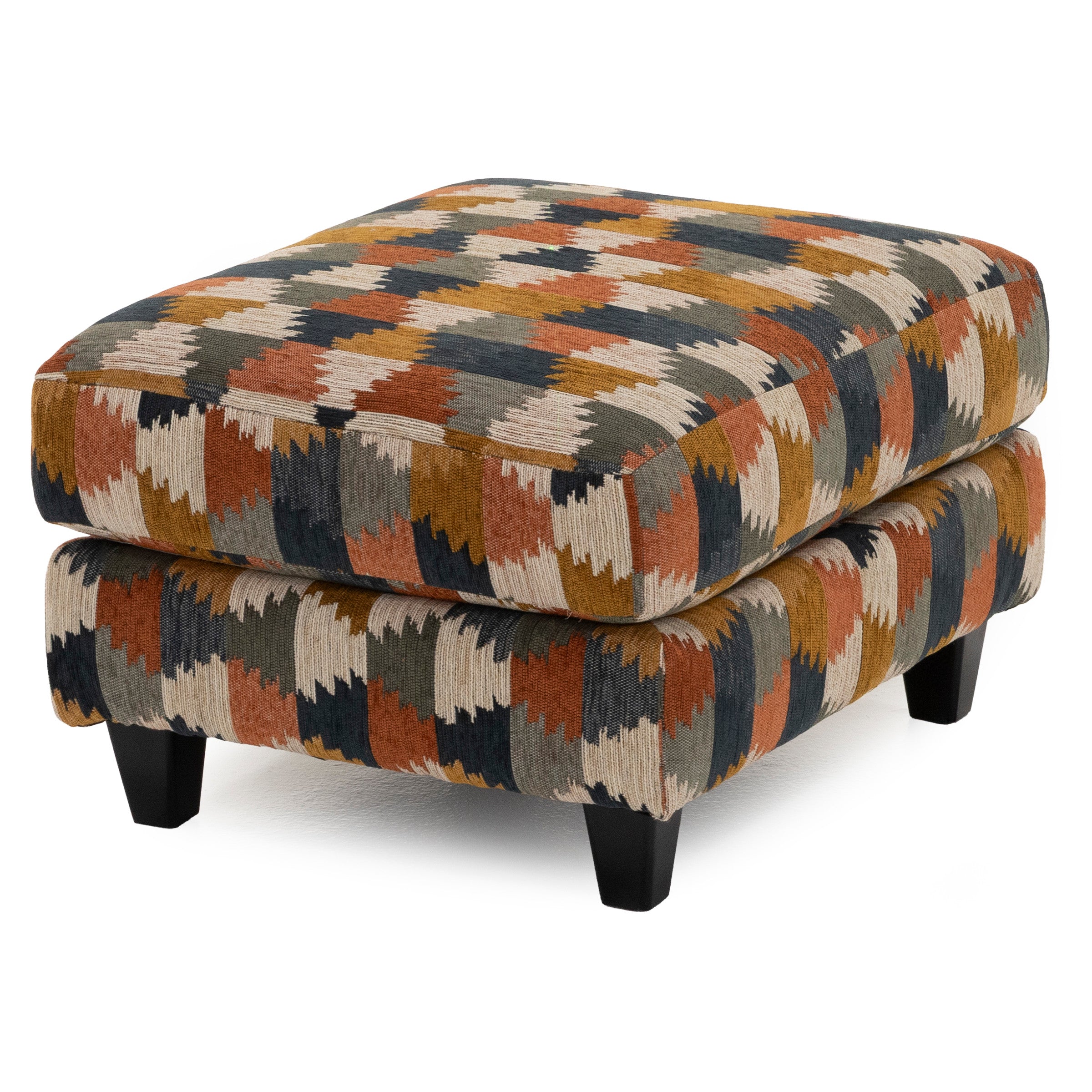 Upholstered ottoman with geometric pattern in earth tones, elevated on four short legs.