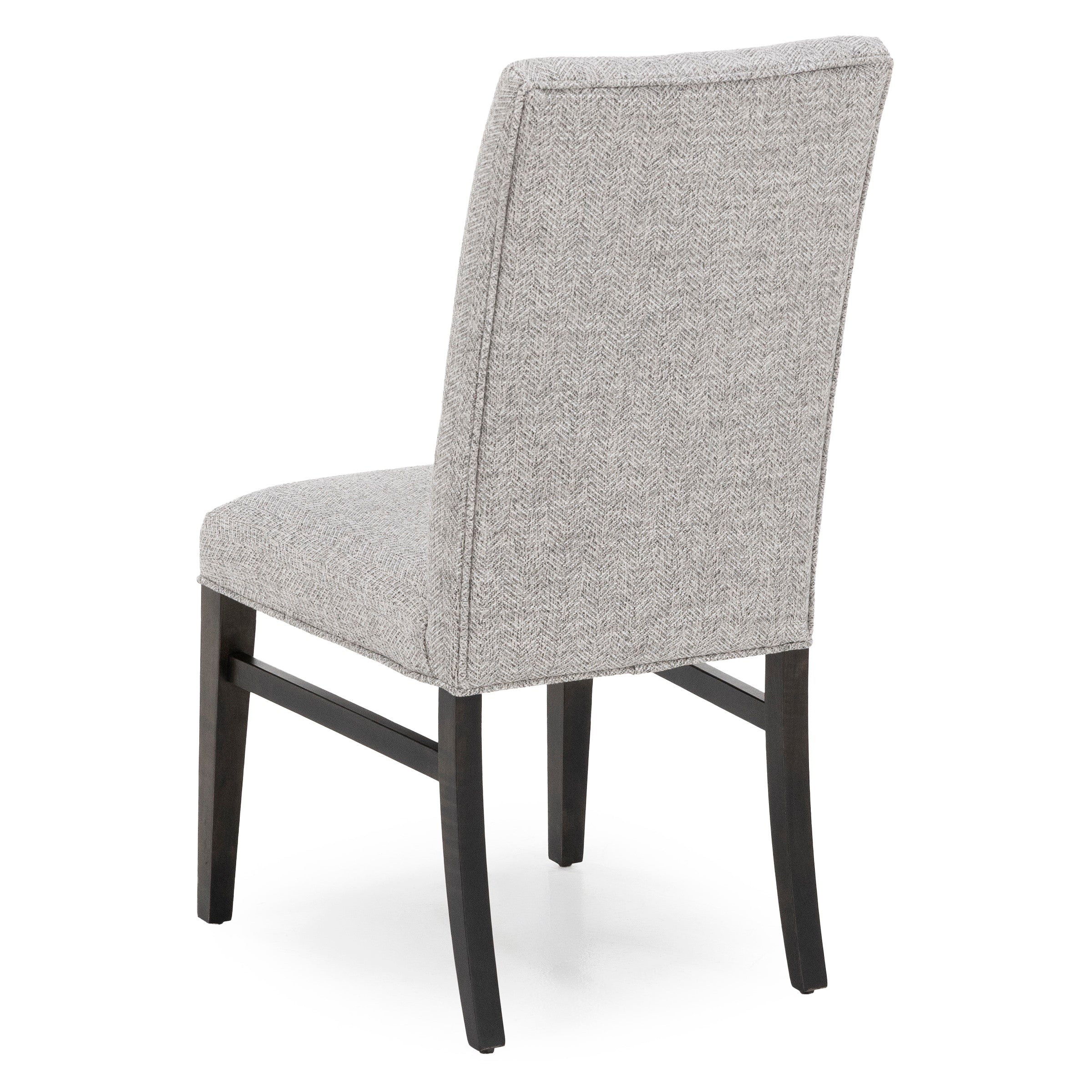 Back view of upholstered dining chair with textured gray fabric and dark wooden legs.