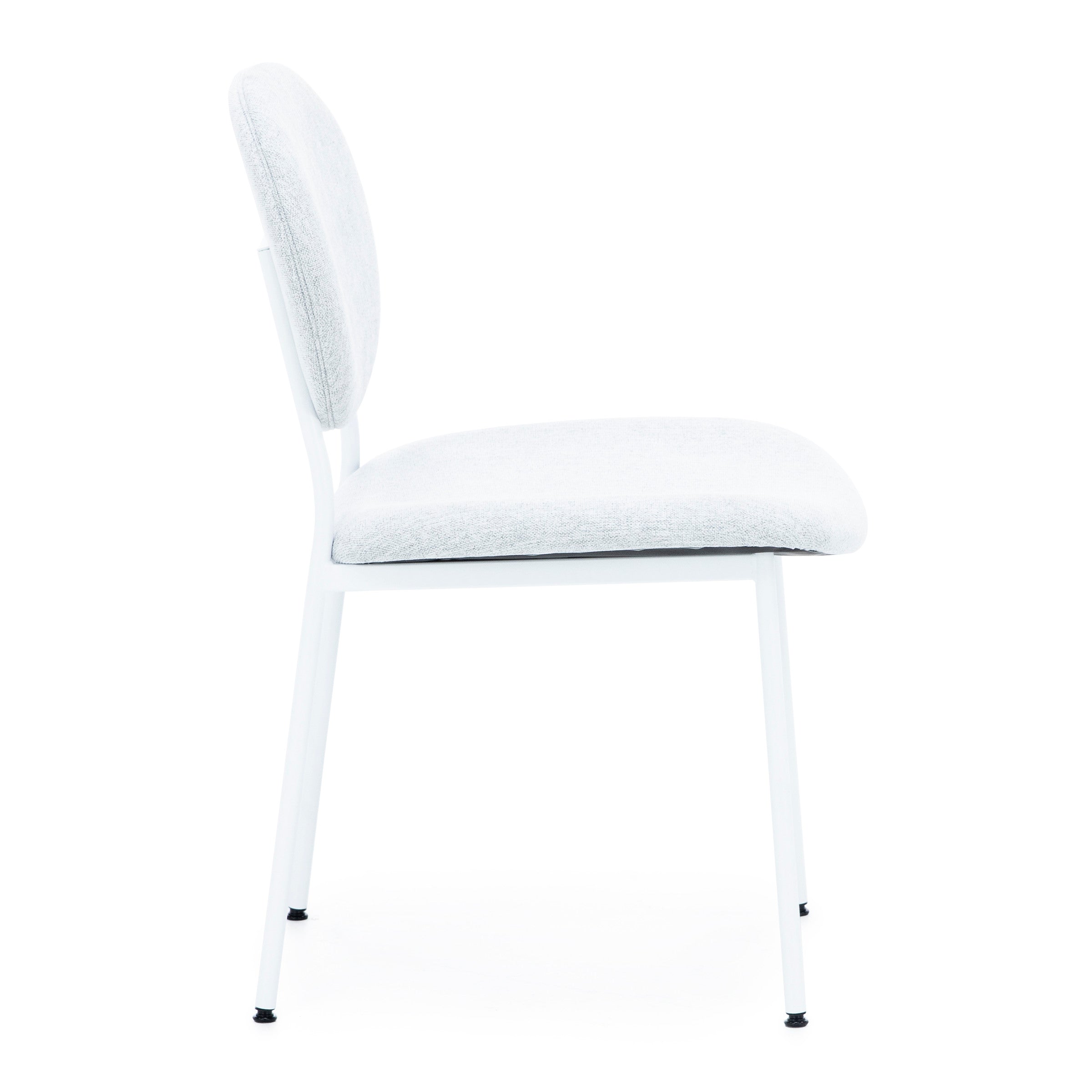 Modern white chair with round padded back and seat, metal frame, side view.