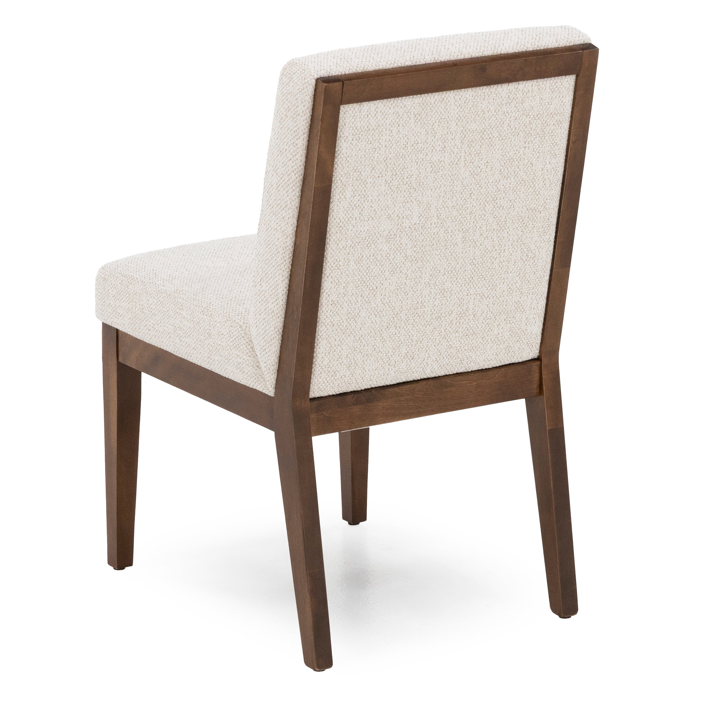 Angled view of a modern dining chair with light fabric upholstery and wooden frame.