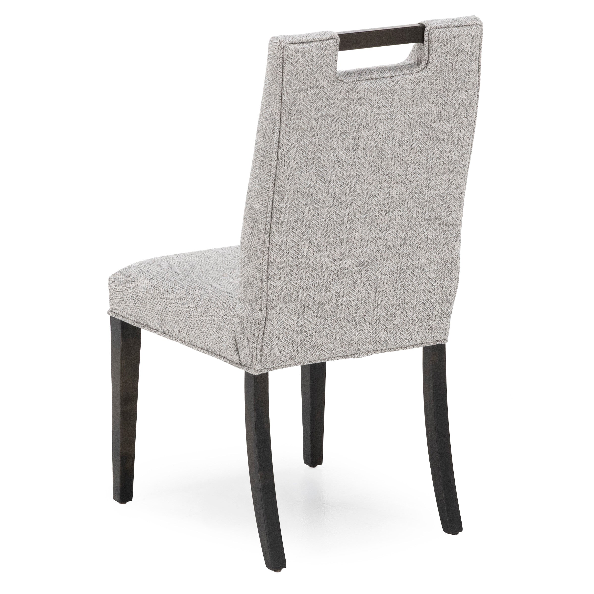 Gray upholstered dining chair, back view with cutout handle and dark wooden legs.
