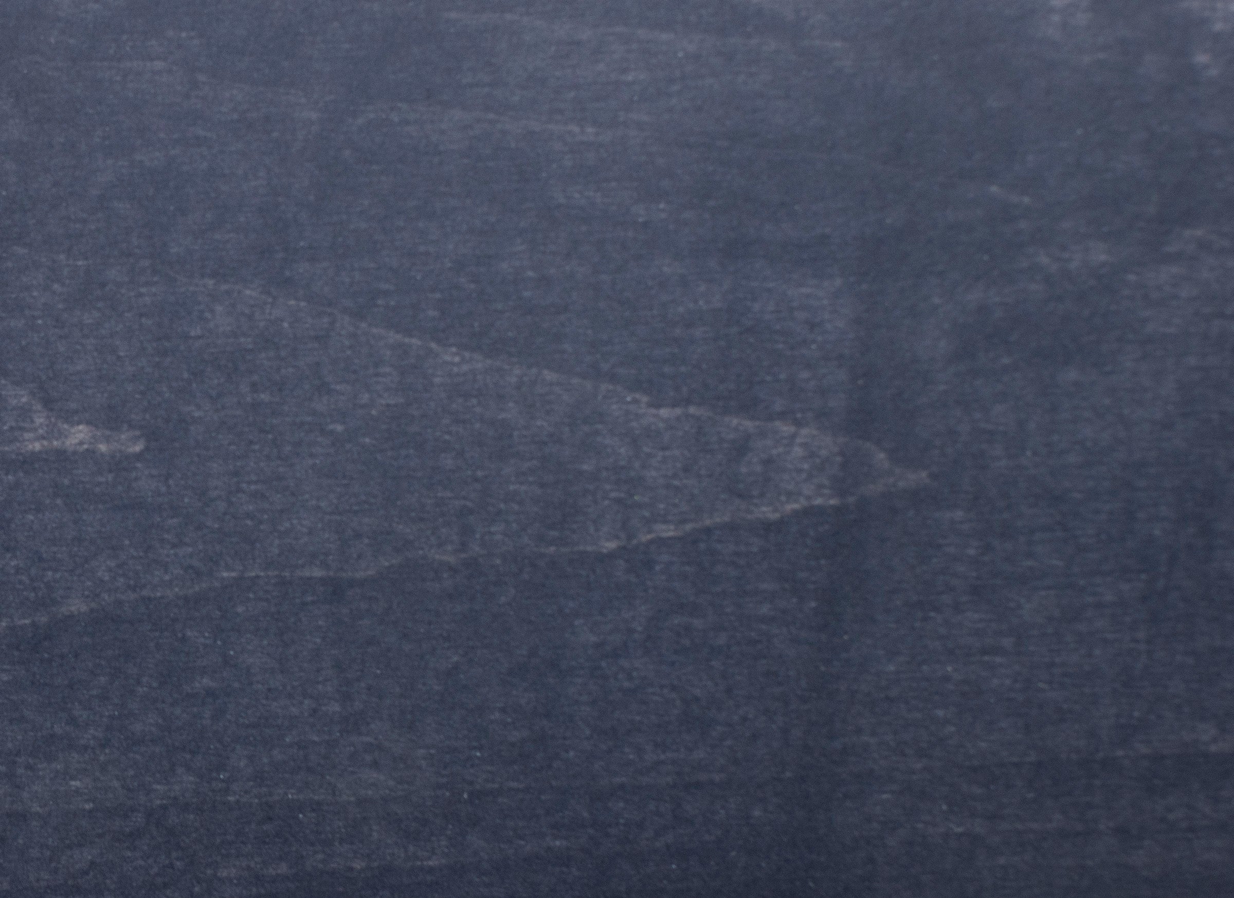 Dark blue denim fabric texture with faded areas
