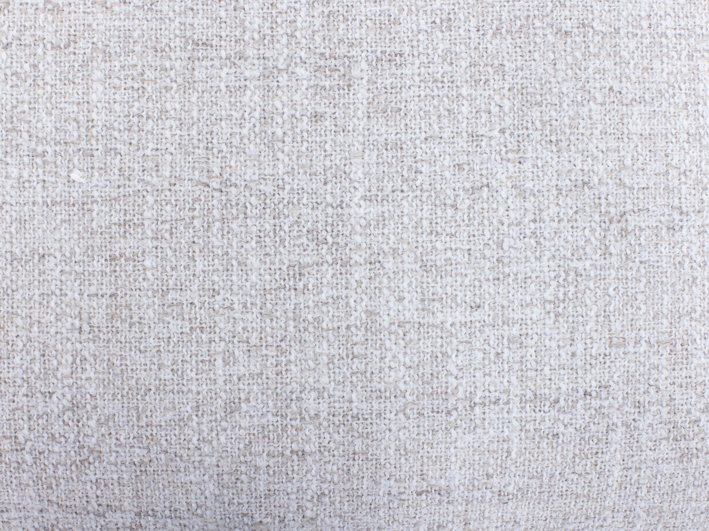 Close-up of light beige textured fabric.
