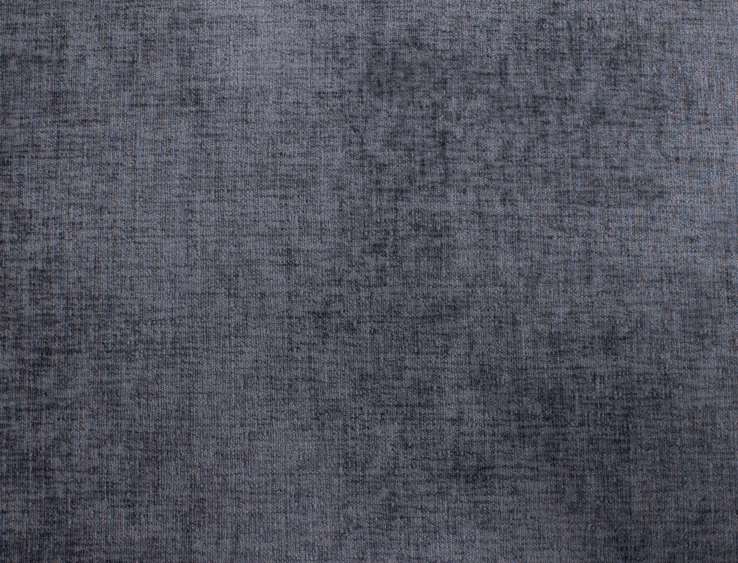 Textured dark gray fabric swatch with subtle shadowing.