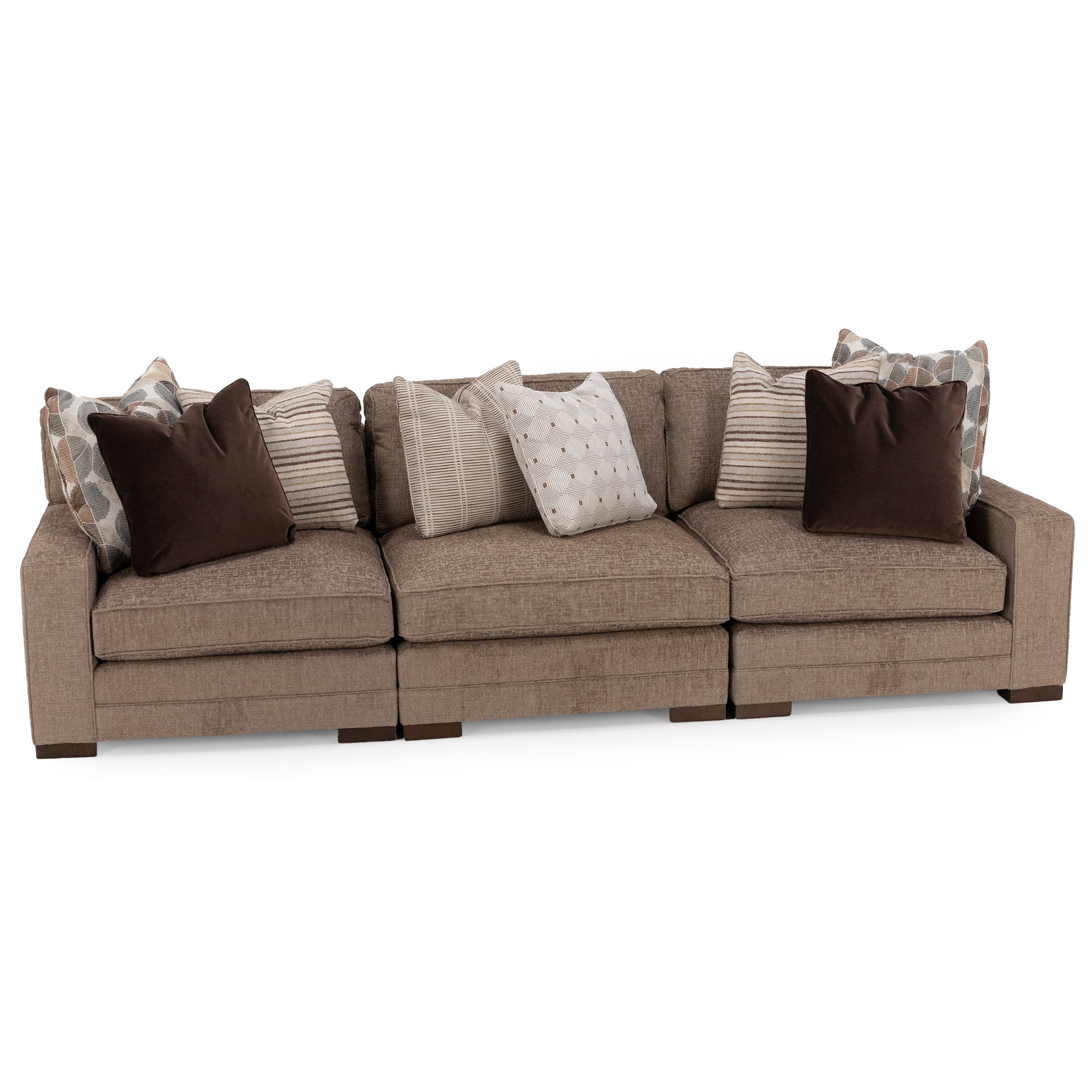 Beige three-seat sofa with assorted patterned and solid throw pillows.