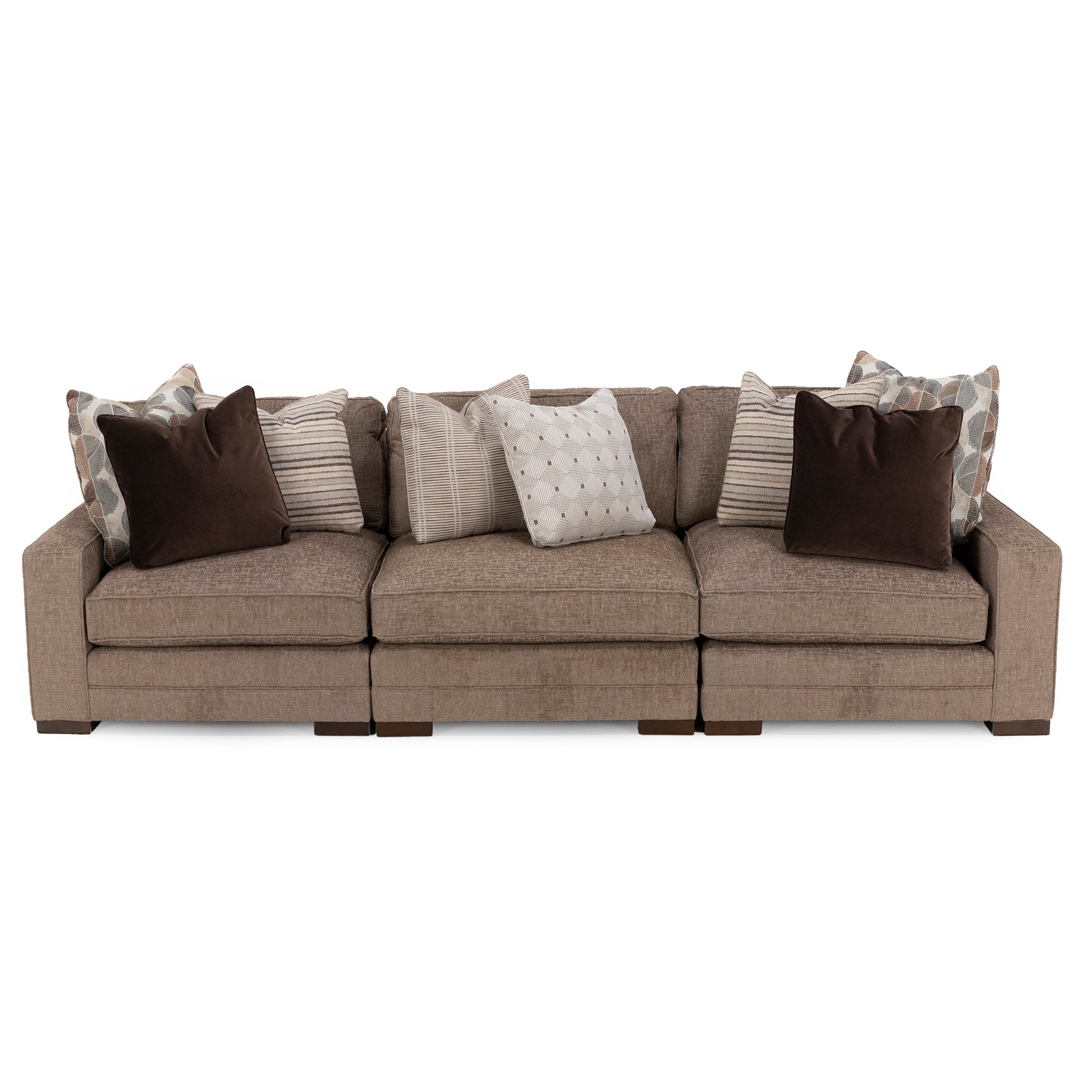 Brown fabric sofa with multiple patterned and solid throw pillows, viewed from the front.