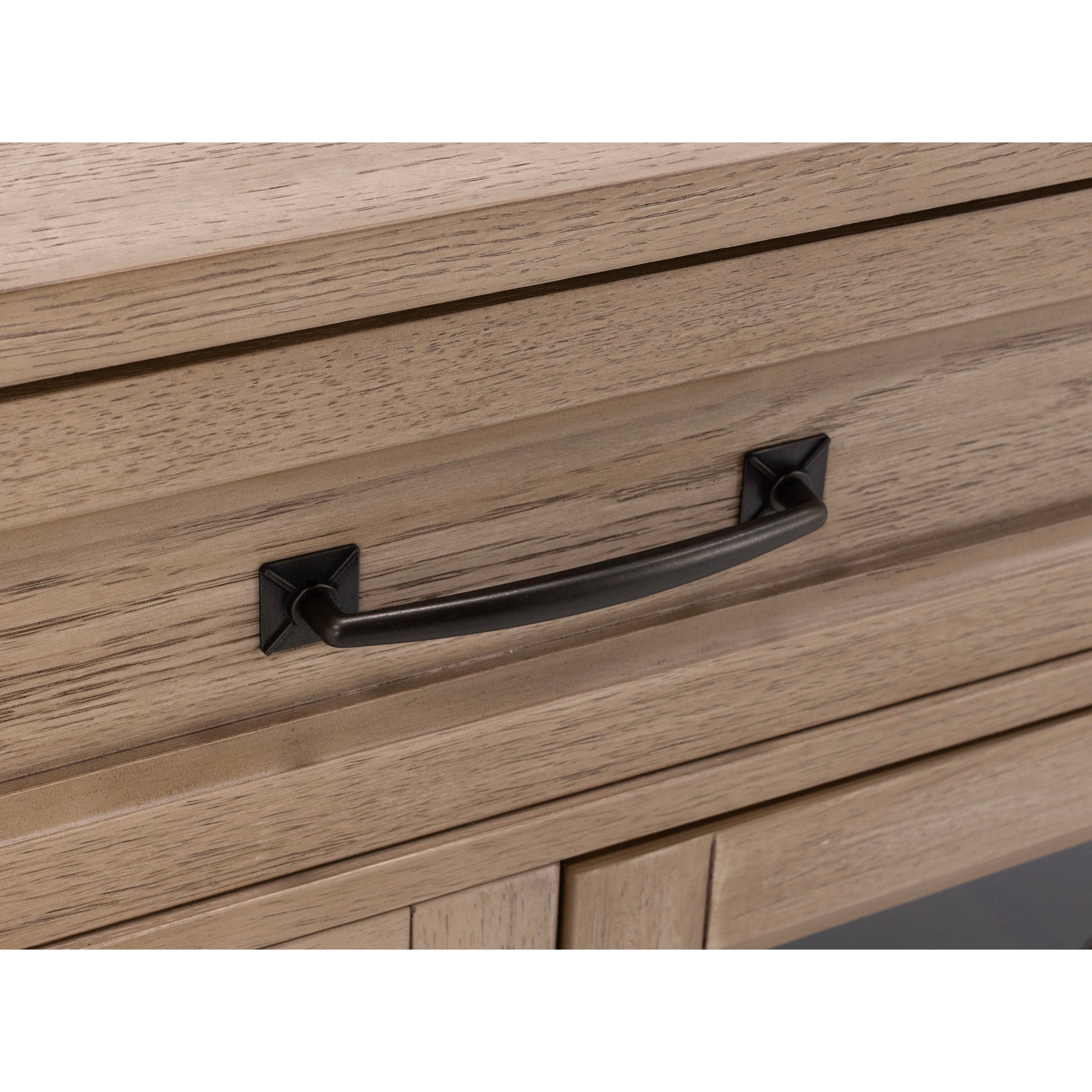 Close-up of a wood drawer with a black metal handle.