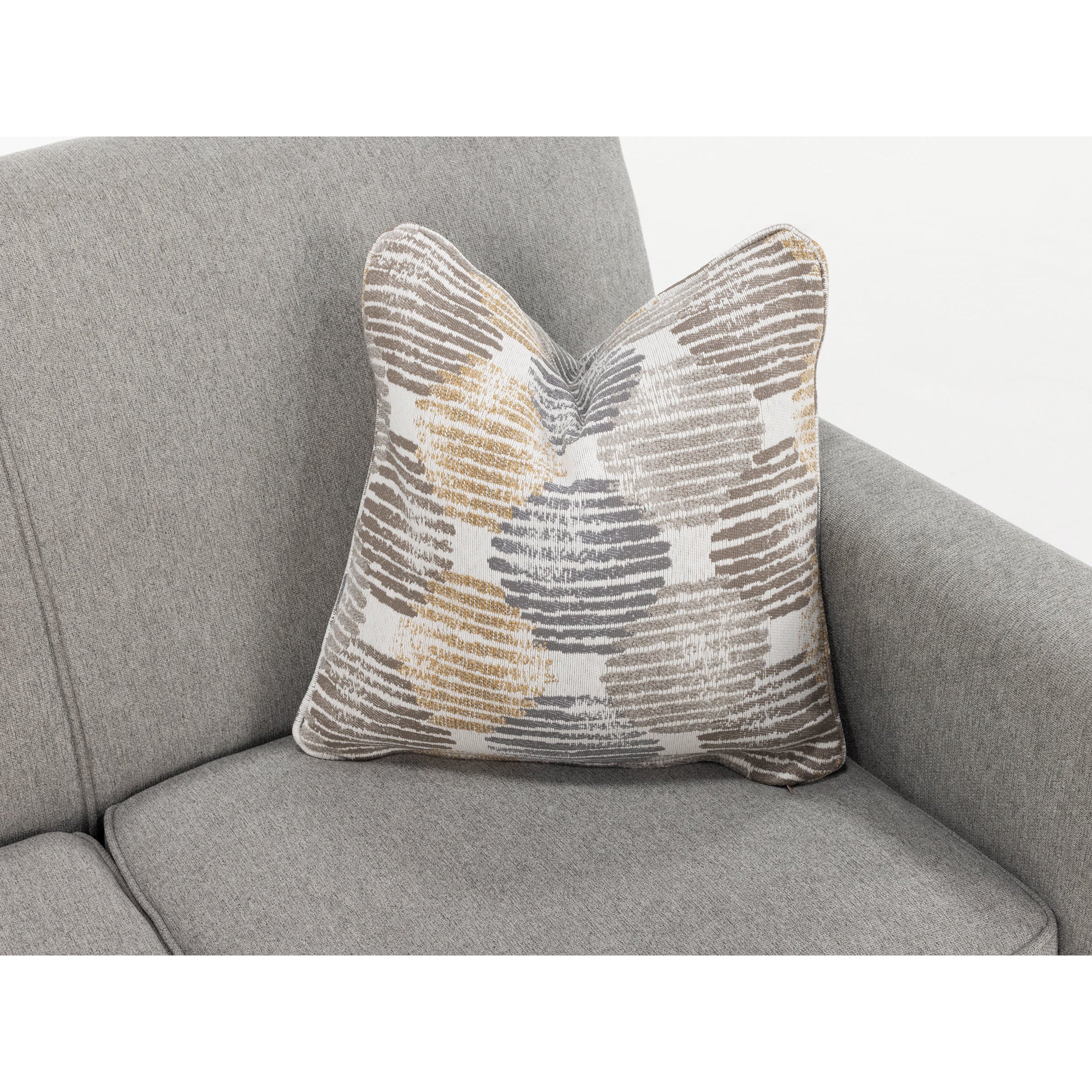 Patterned pillow on a grey sofa, highlighting modern home decor.