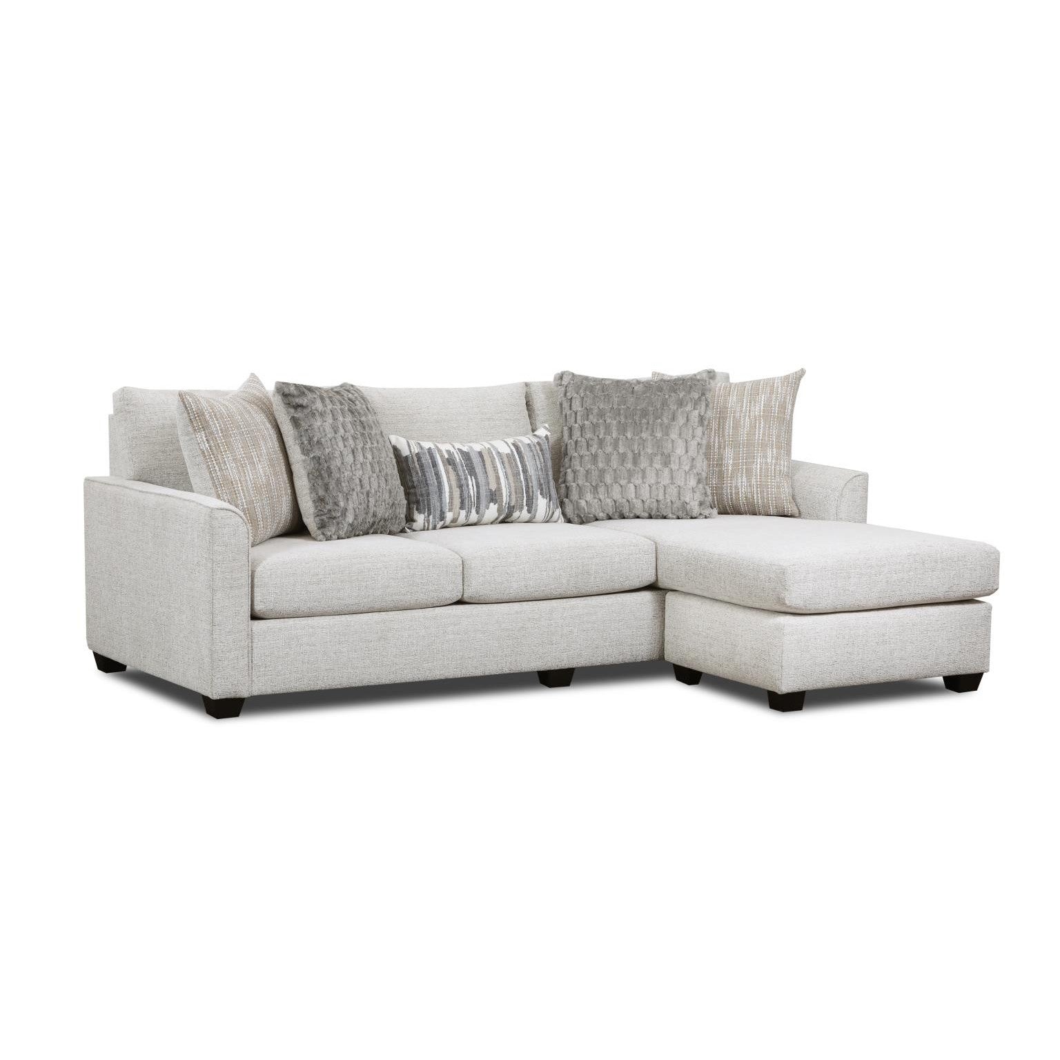 Light gray sectional sofa with chaise, featuring assorted neutral throw pillows.