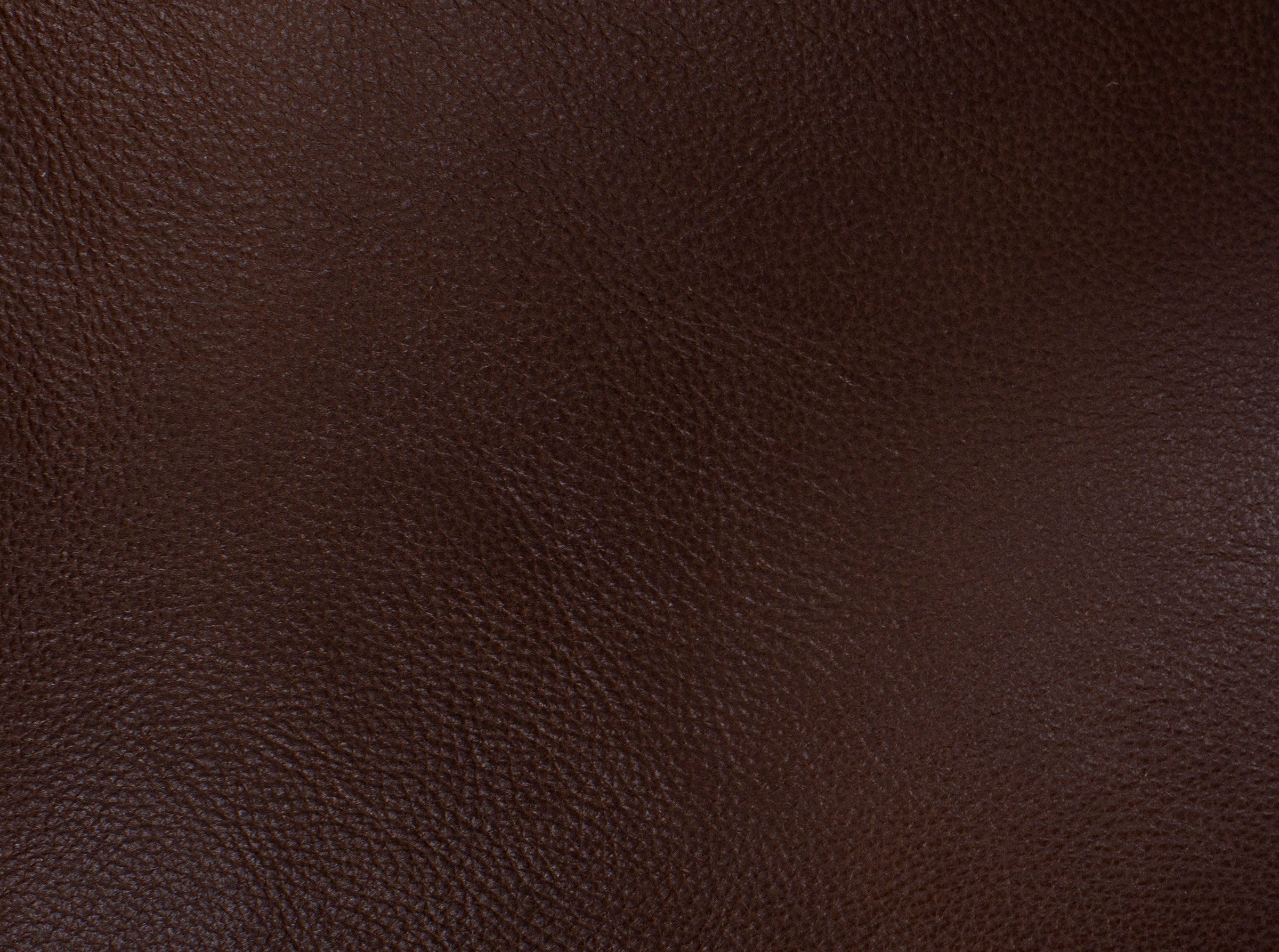 Close-up of dark brown textured leather material.