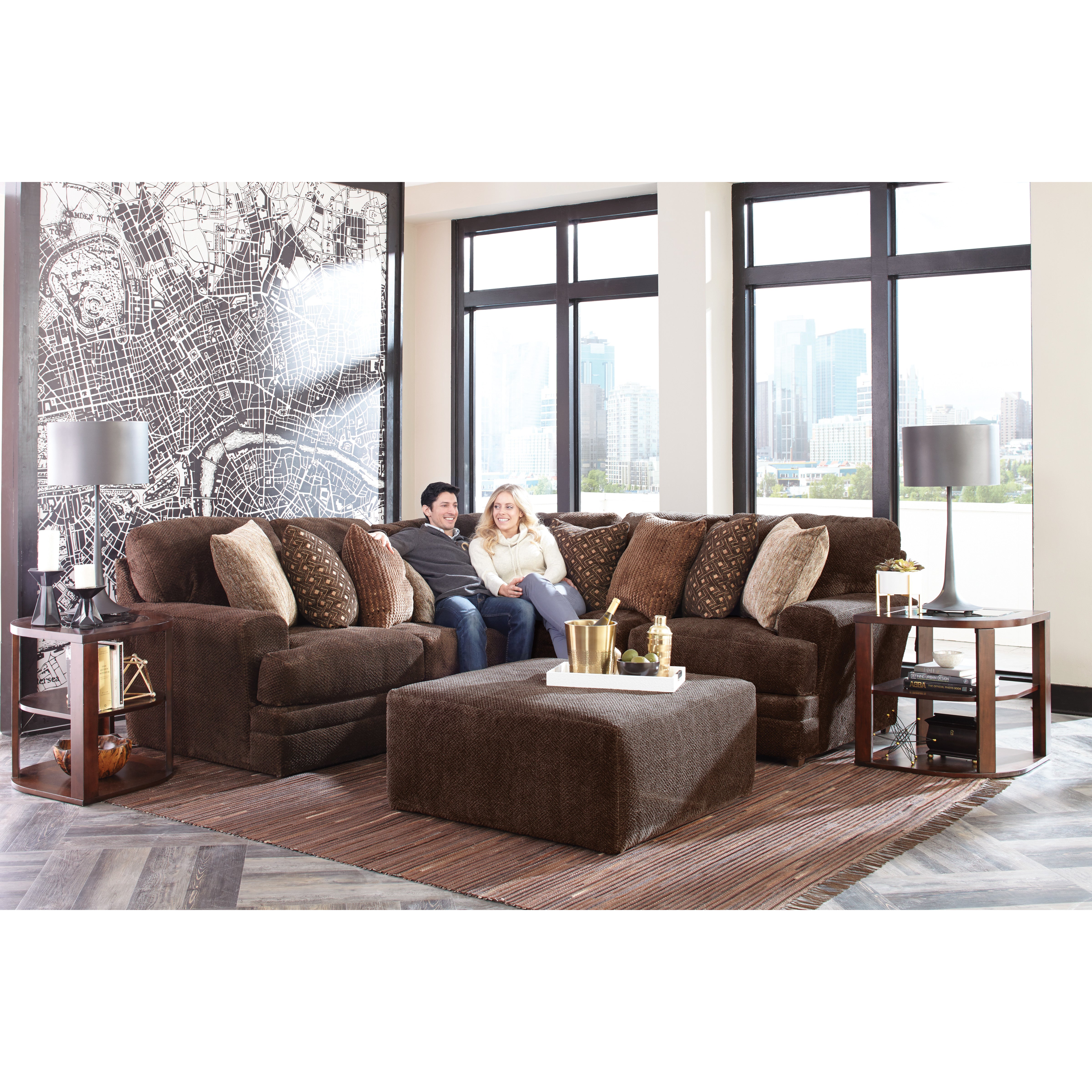 Living room with brown sectional sofa, accent pillows, modern decor and city view.