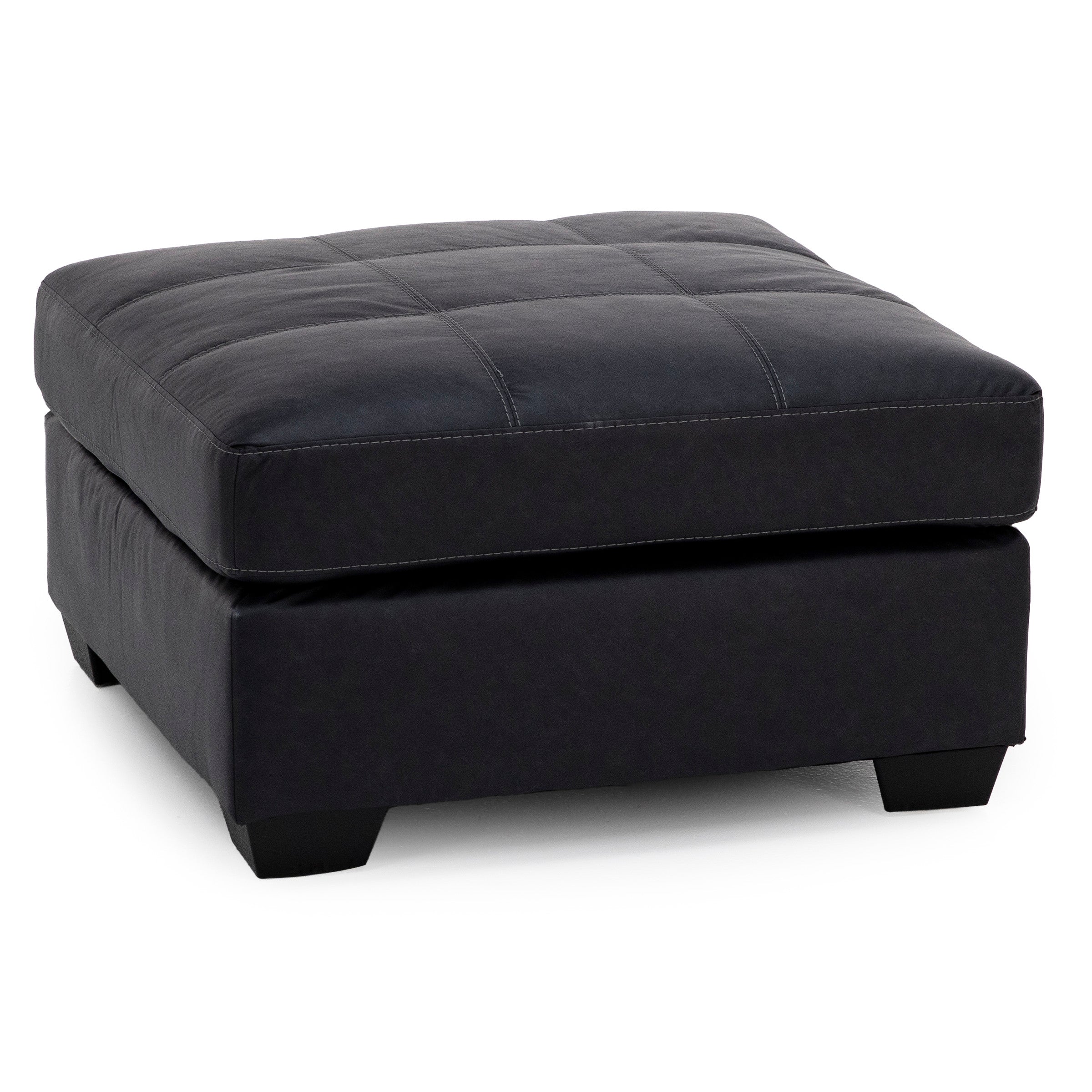 Black square ottoman with tufted top and short legs.