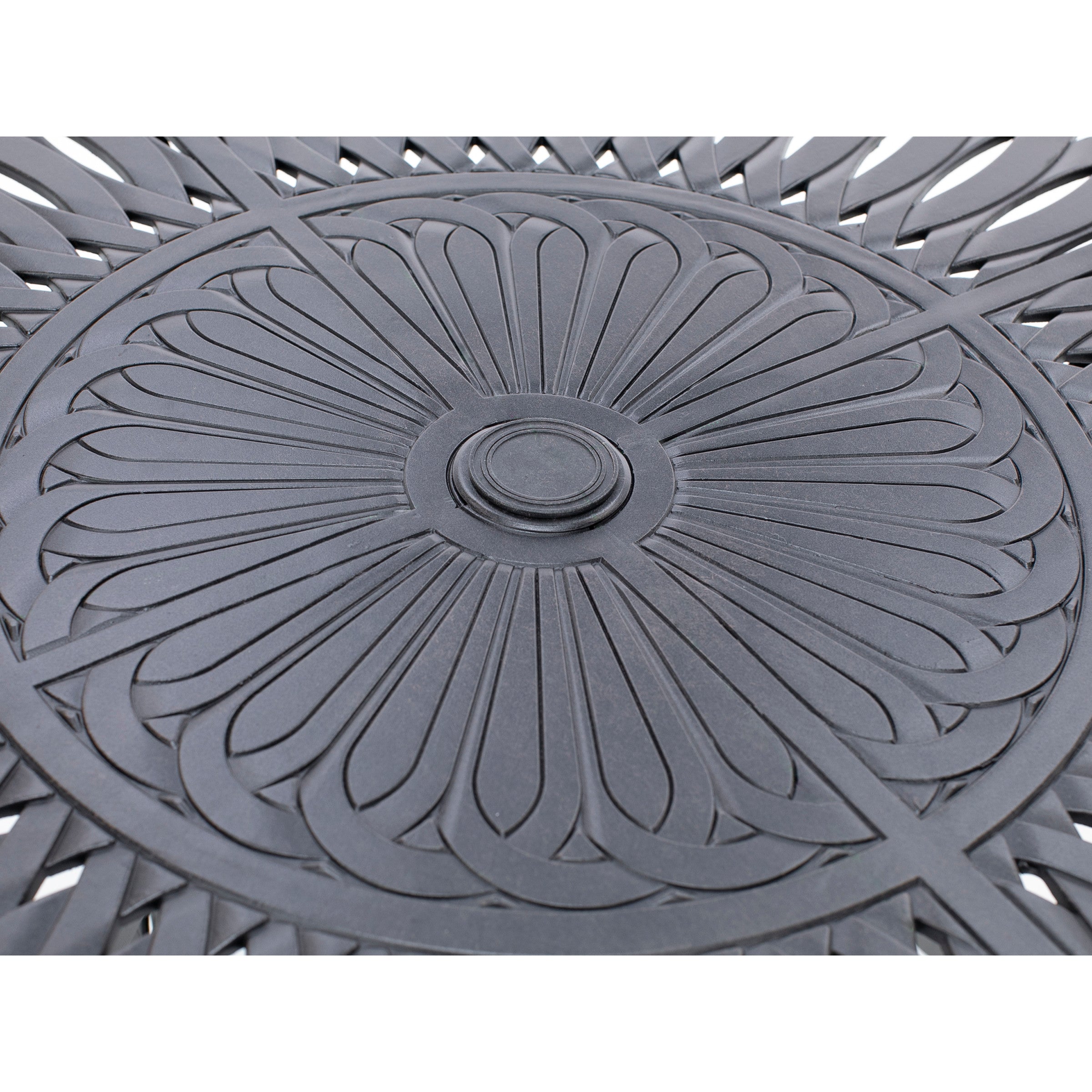 Close-up of a black metal outdoor table with a decorative, radial cutout pattern.