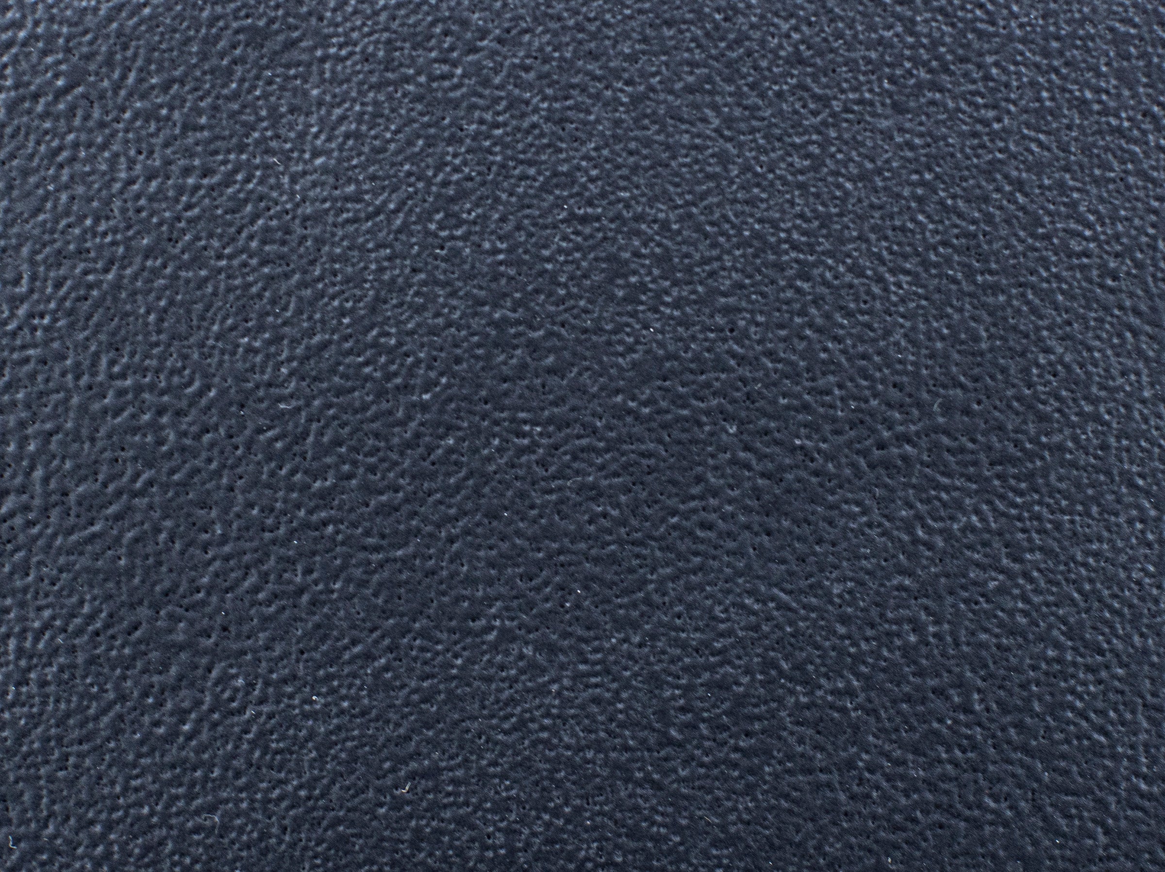 Close-up of dark textured material, possibly black or dark gray leather.