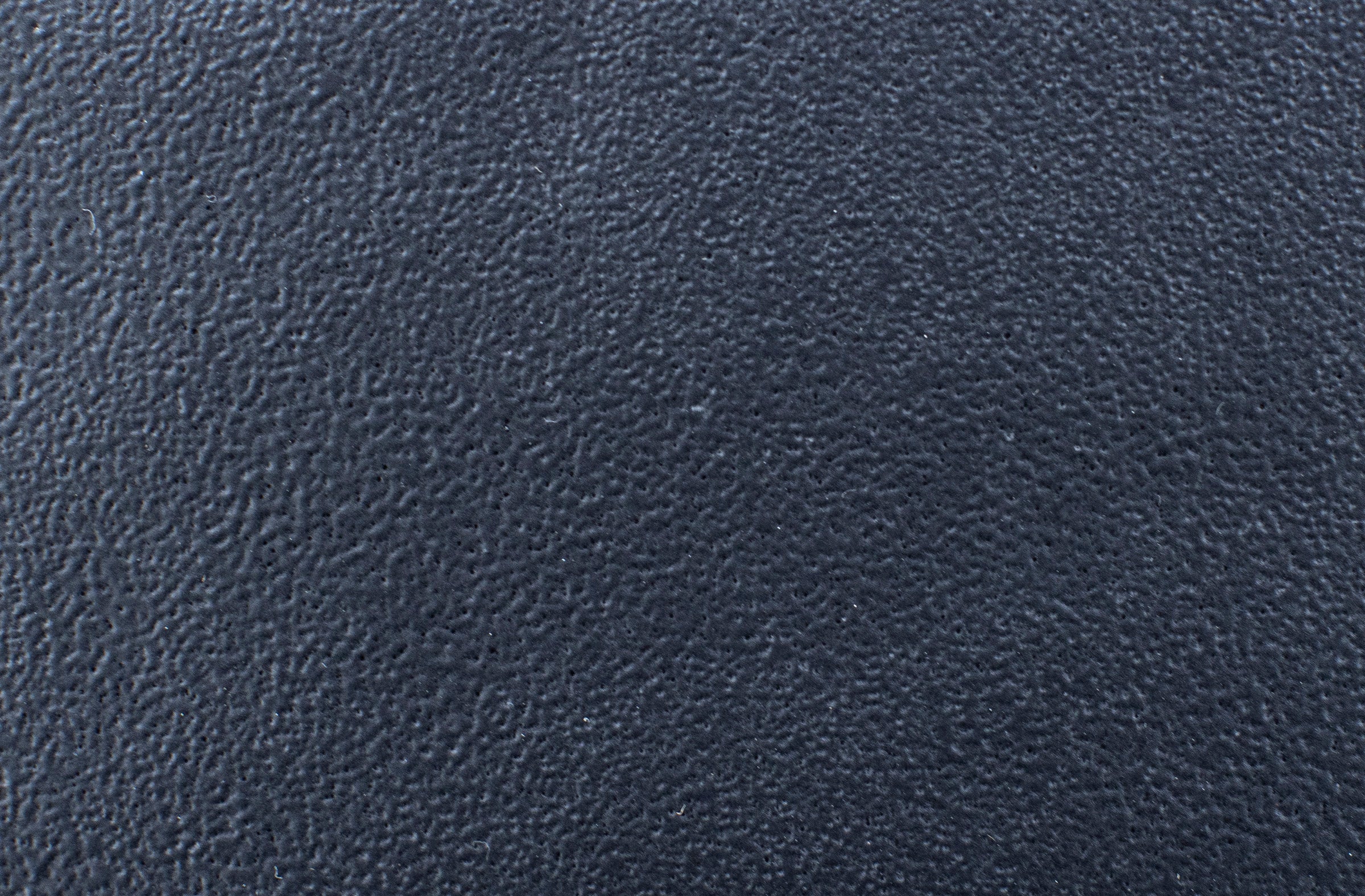 Black textured material surface, close-up.