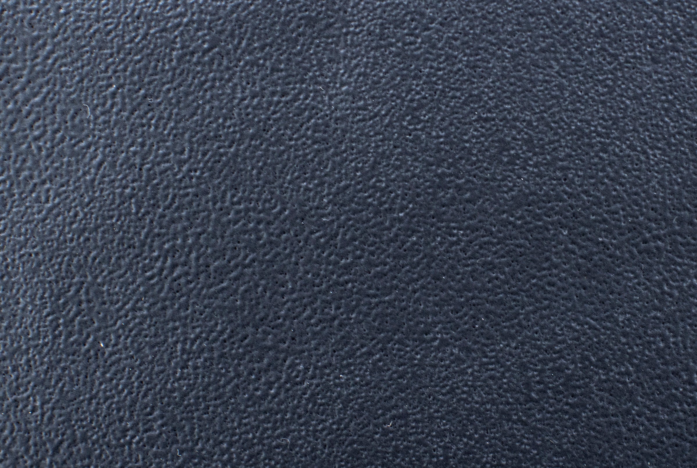 Close-up of dark textured leather material.