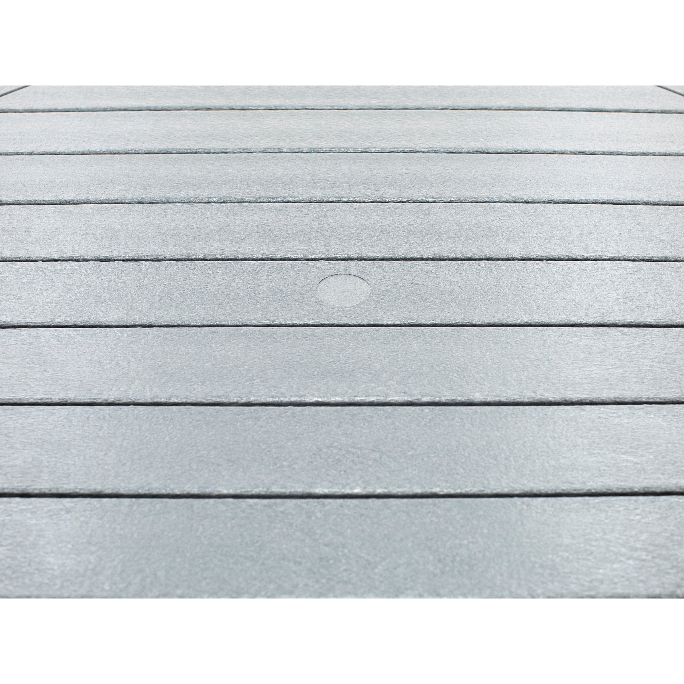 Closeup of a gray slatted table surface with a round umbrella hole in the center.