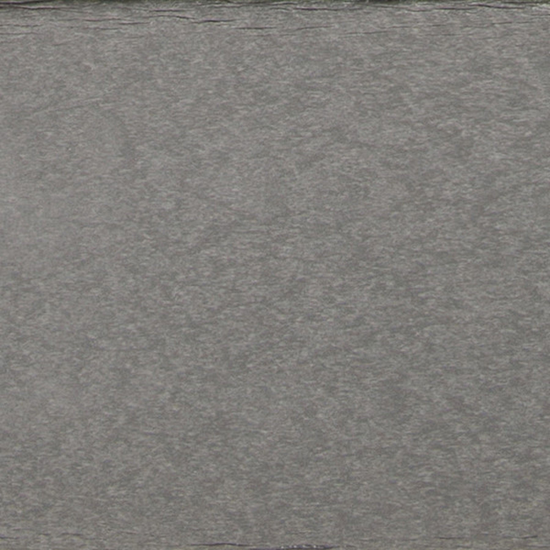 Gray textured surface, likely stone or metal, shown in close-up.