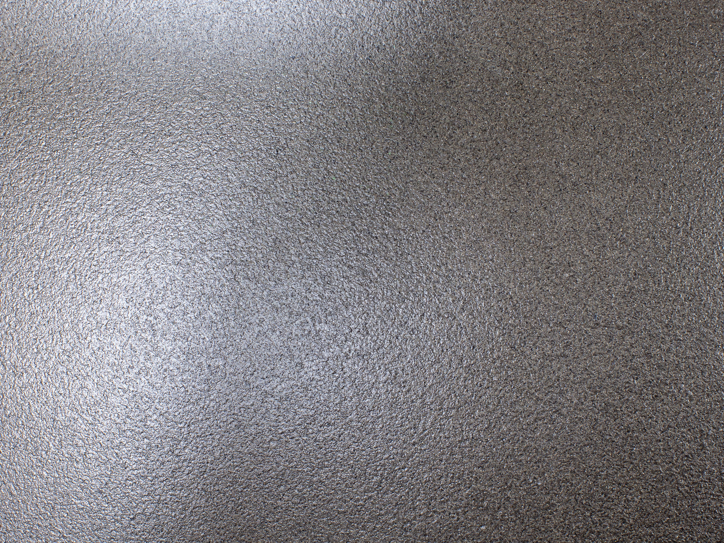Gray textured surface, resembles stone or concrete.