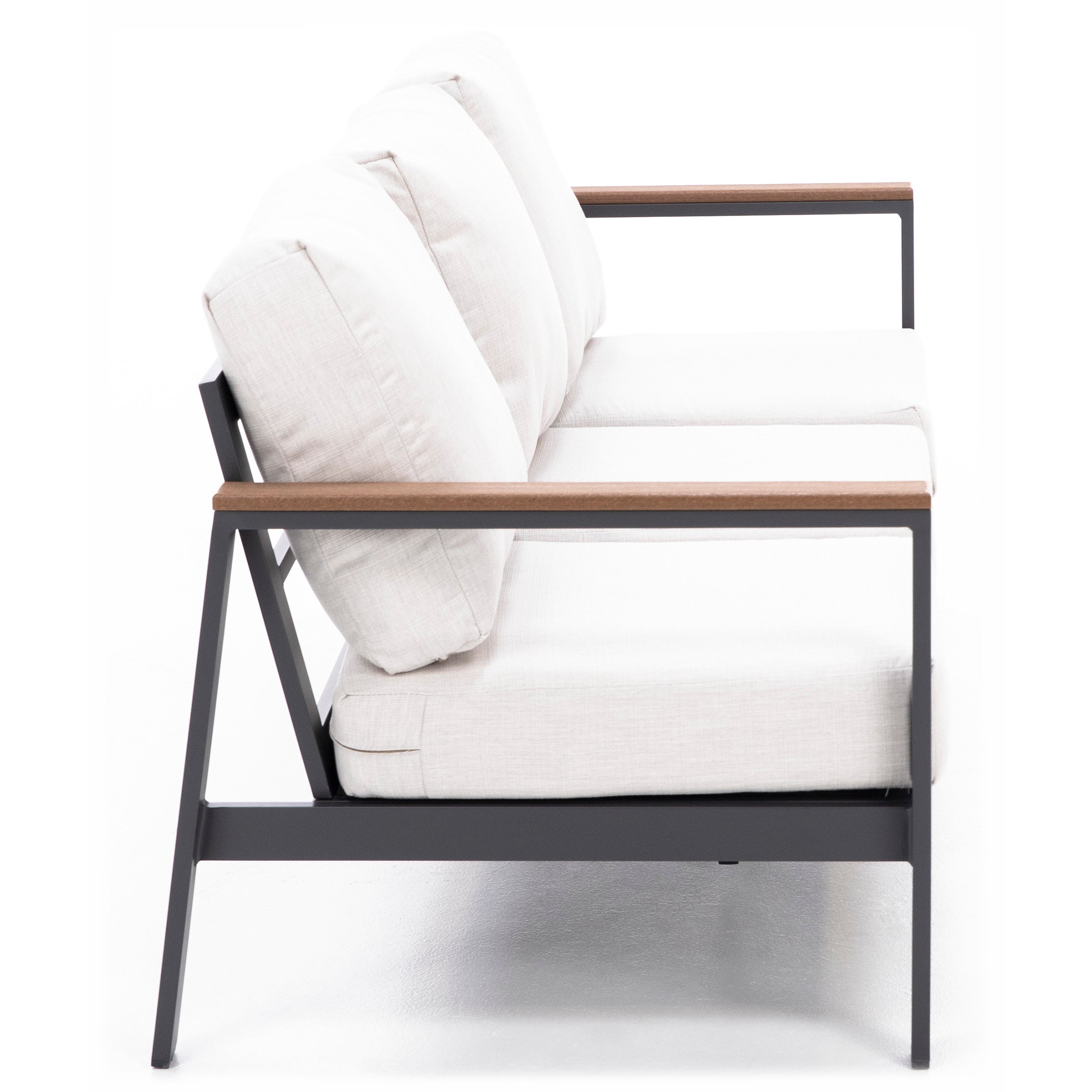 Modern sofa with white cushions, black metal frame and wooden armrests, side view.
