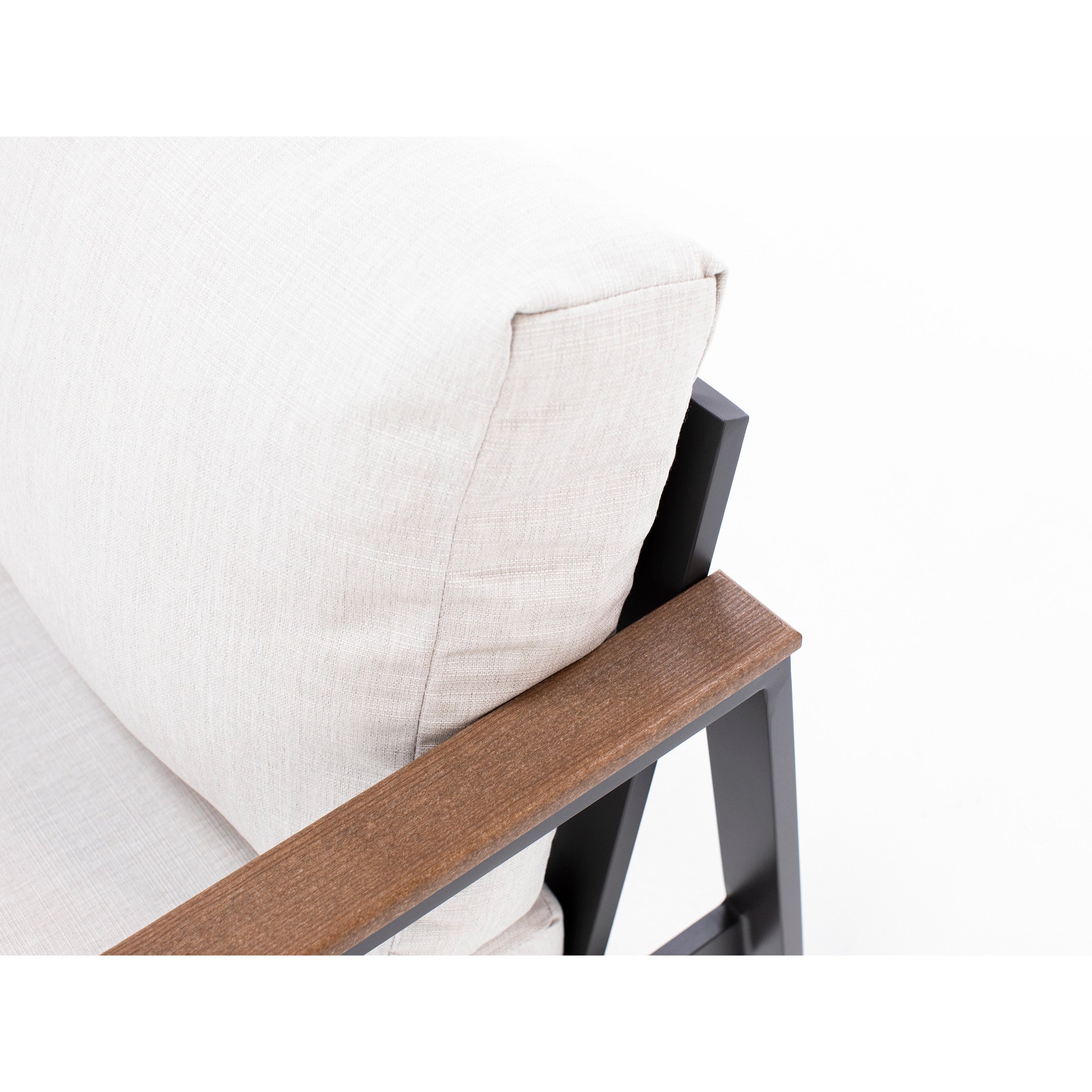 Close-up of beige cushion and wood armrest on a modern metal chair.