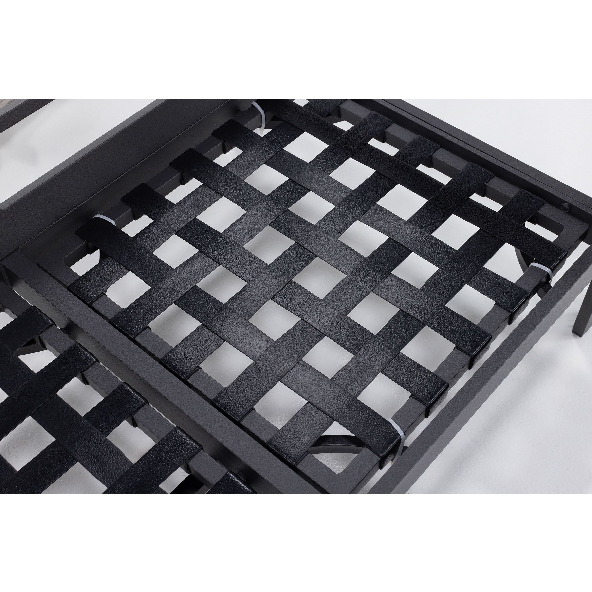 Close-up of black woven straps on a metal furniture frame.
