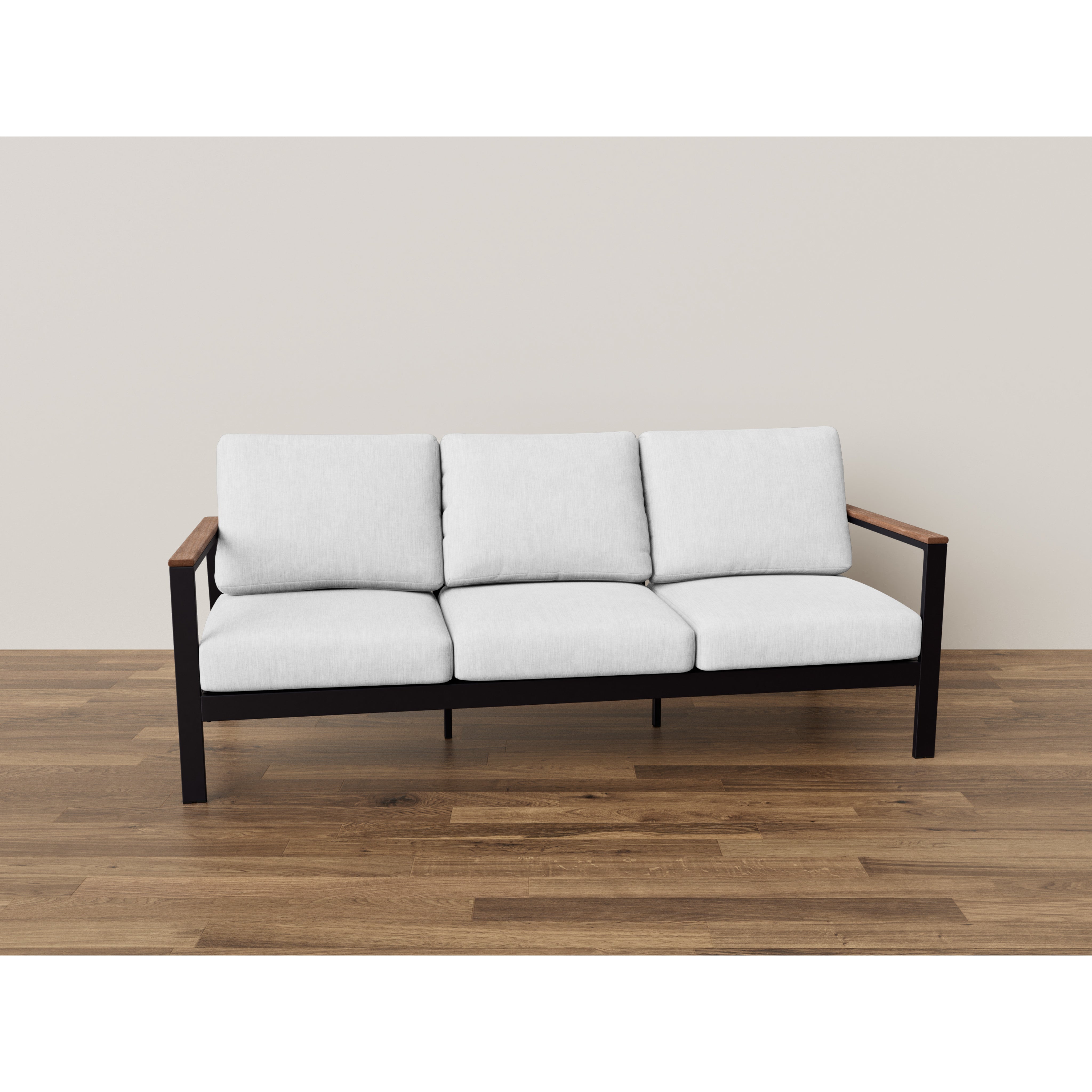 Modern three-seat sofa with white cushions and black frame on wooden floor.