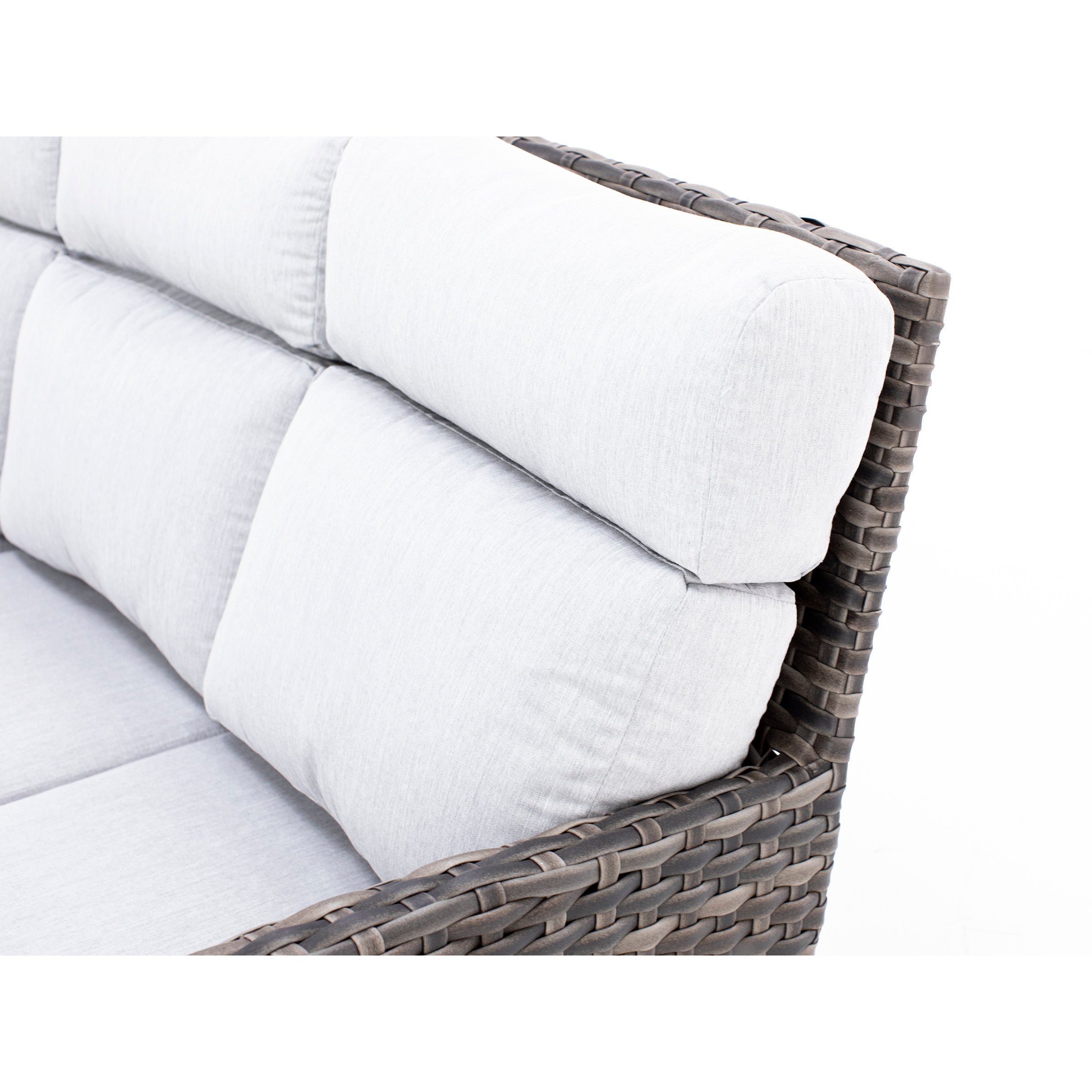 Closeup of a gray outdoor sofa with woven frame and padded back cushions.