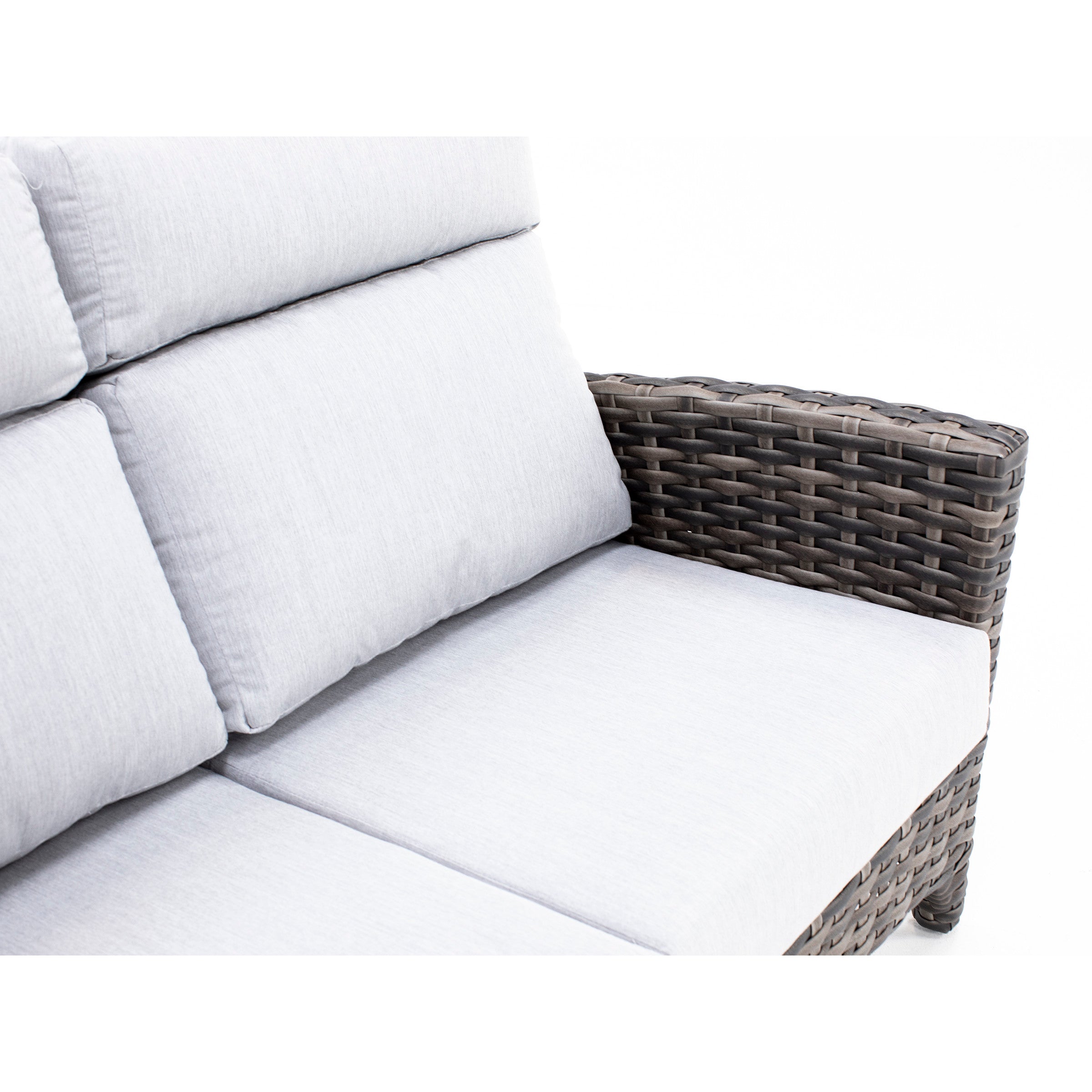 Light gray cushioned outdoor sofa with dark woven wicker armrest.