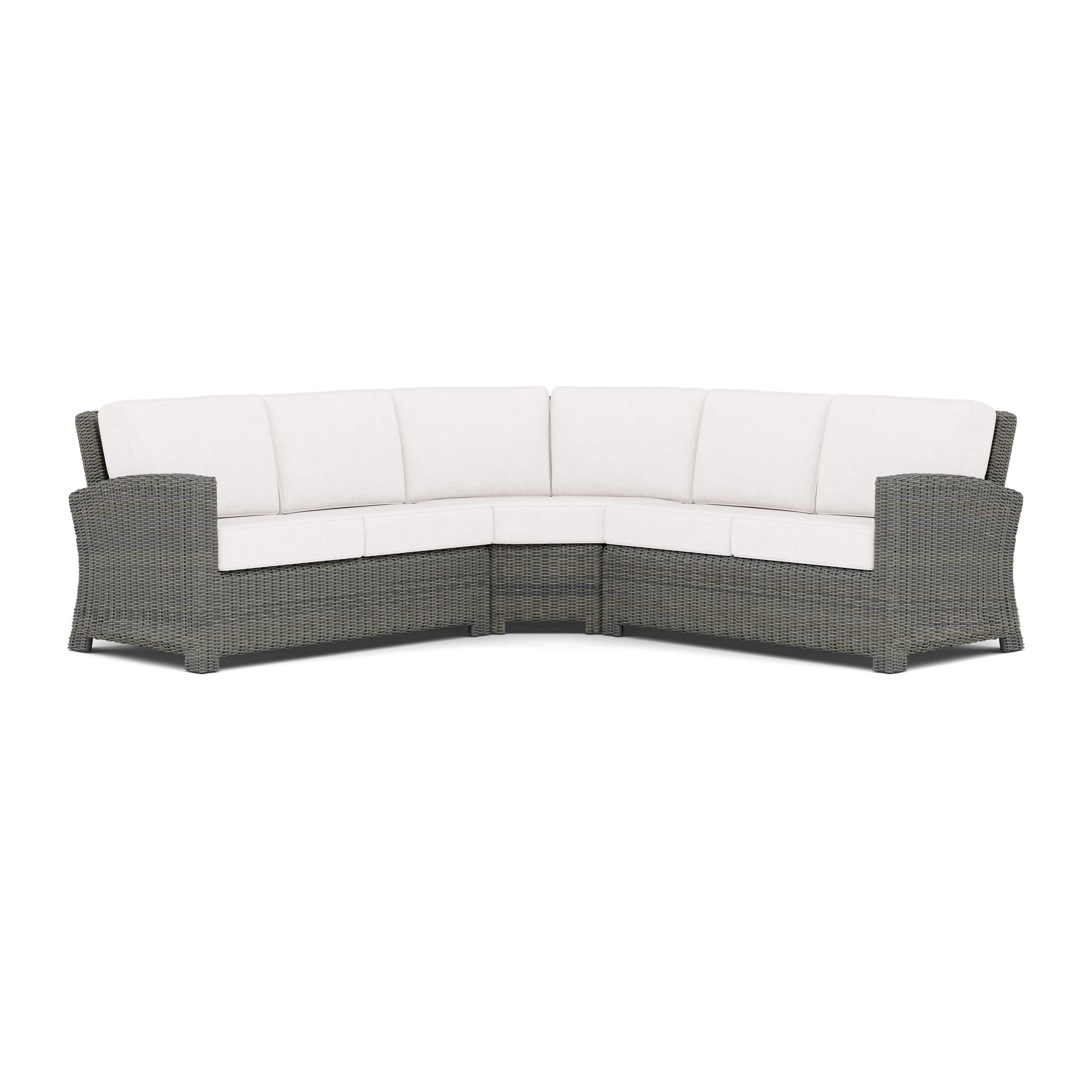 Outdoor sectional sofa with gray wicker frame and white cushions.