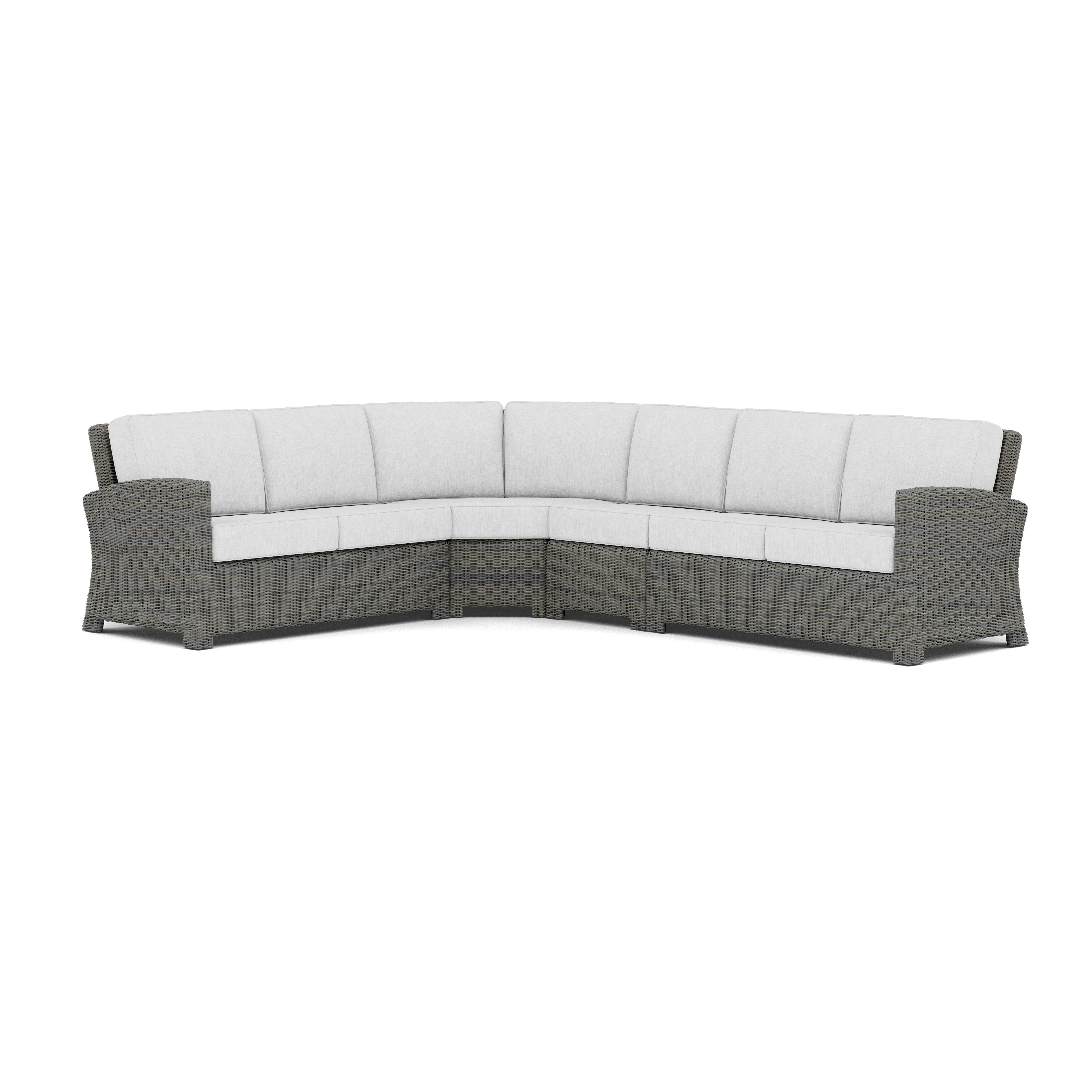 Gray wicker outdoor sectional sofa with light cushions, shown against a white background.