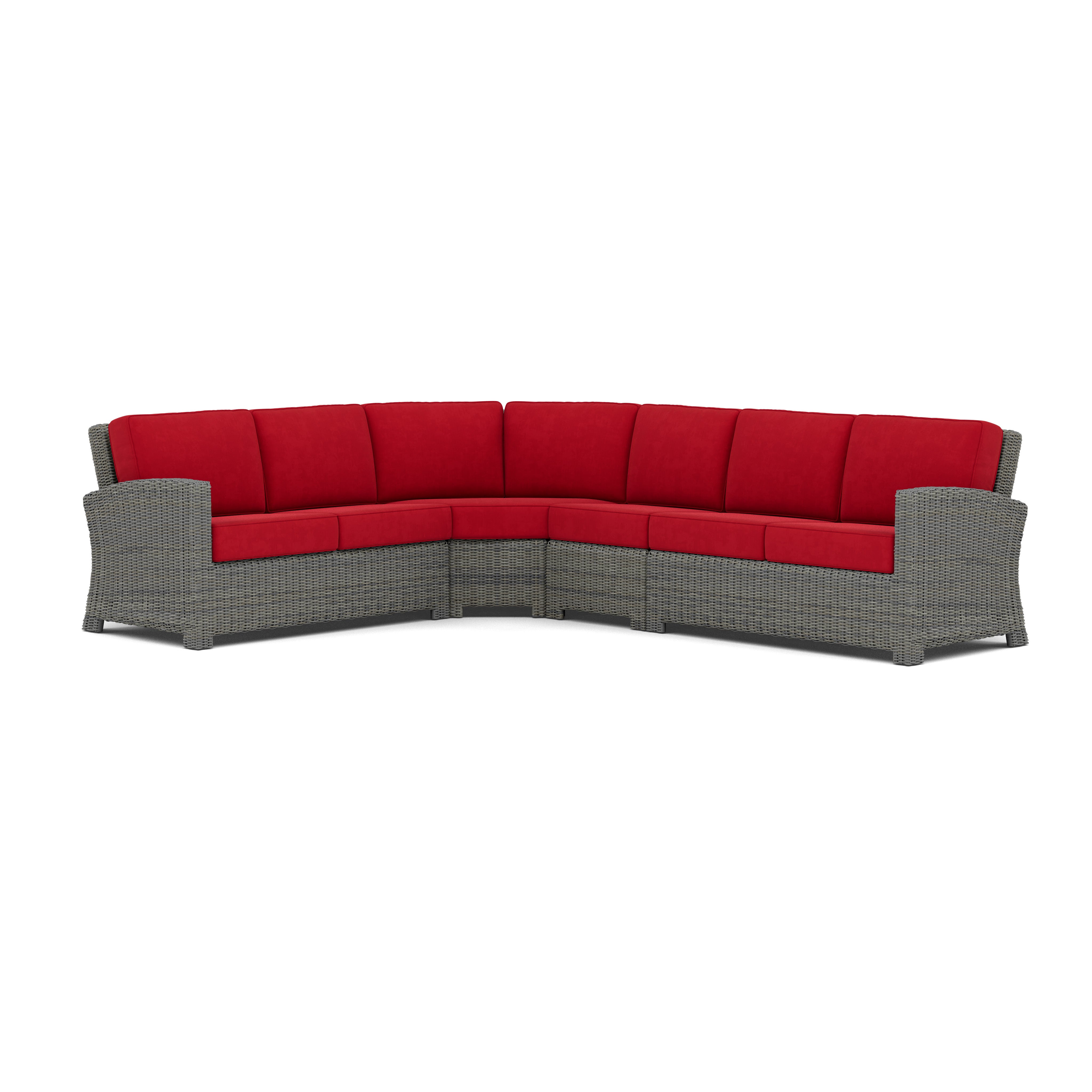 Gray wicker outdoor sectional sofa with red cushions.