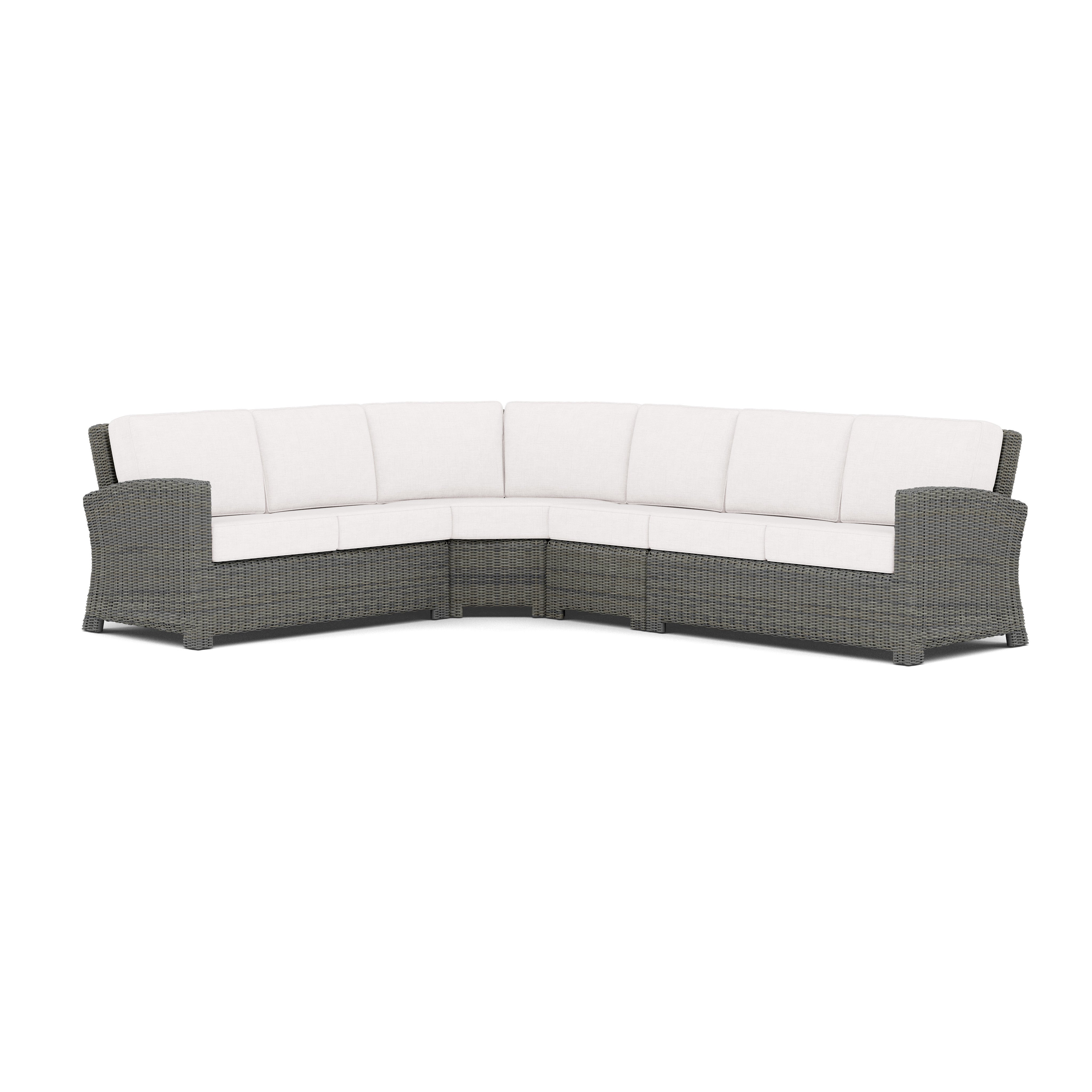 Gray outdoor sectional sofa with white cushions, L-shaped design.