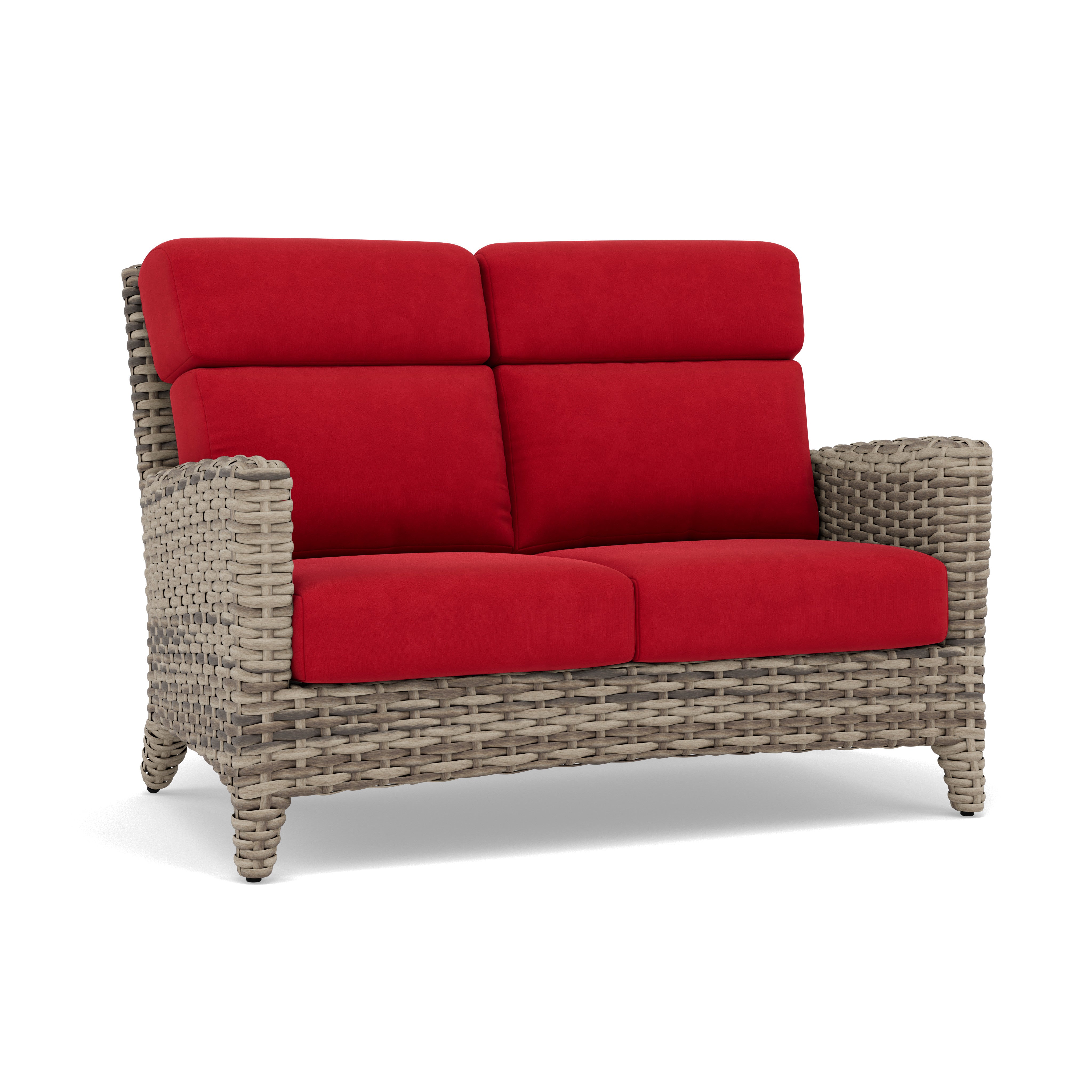 Woven wicker loveseat with red cushions, suitable for outdoor seating.