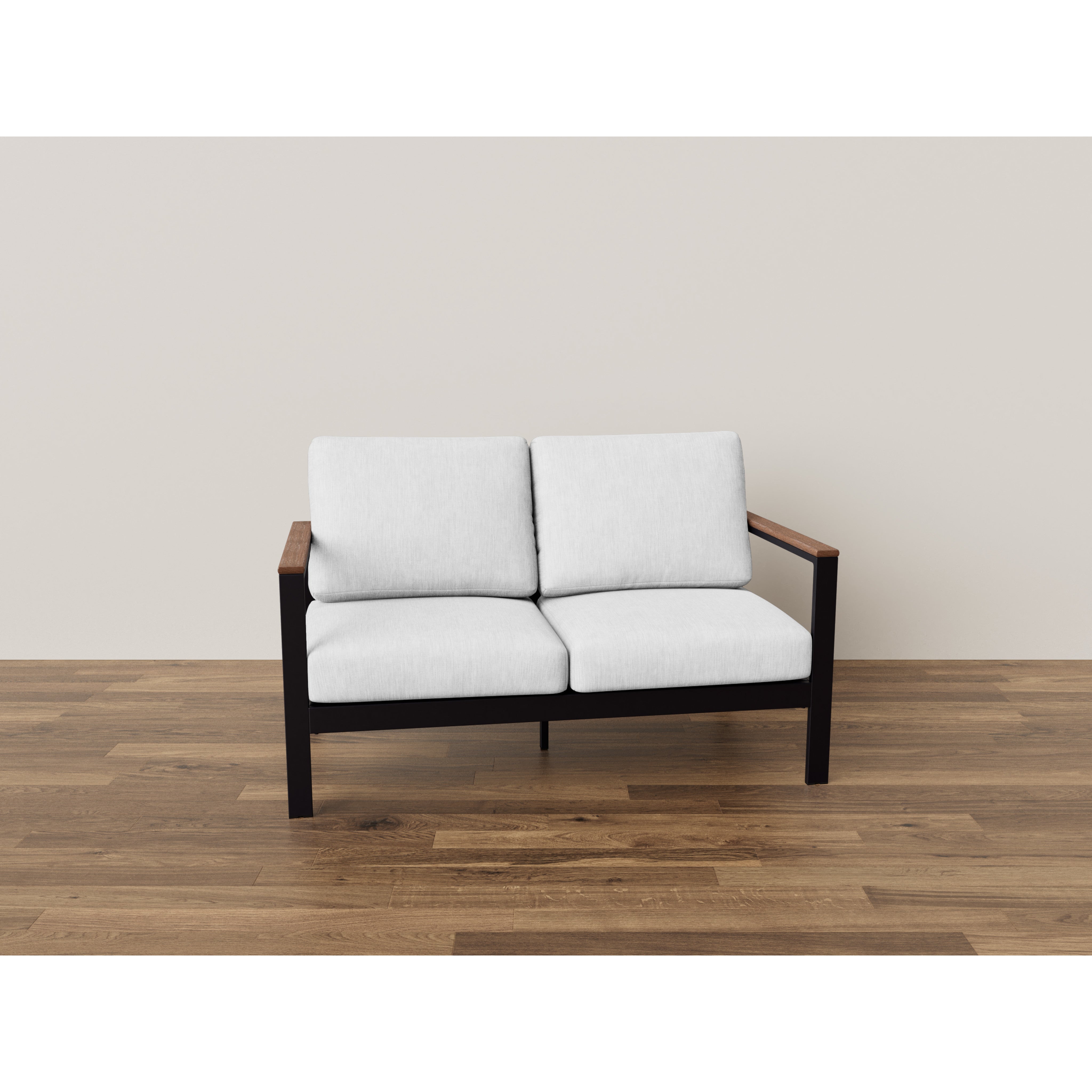 Modern loveseat with white cushions, black frame, and wood arms on a wooden floor.