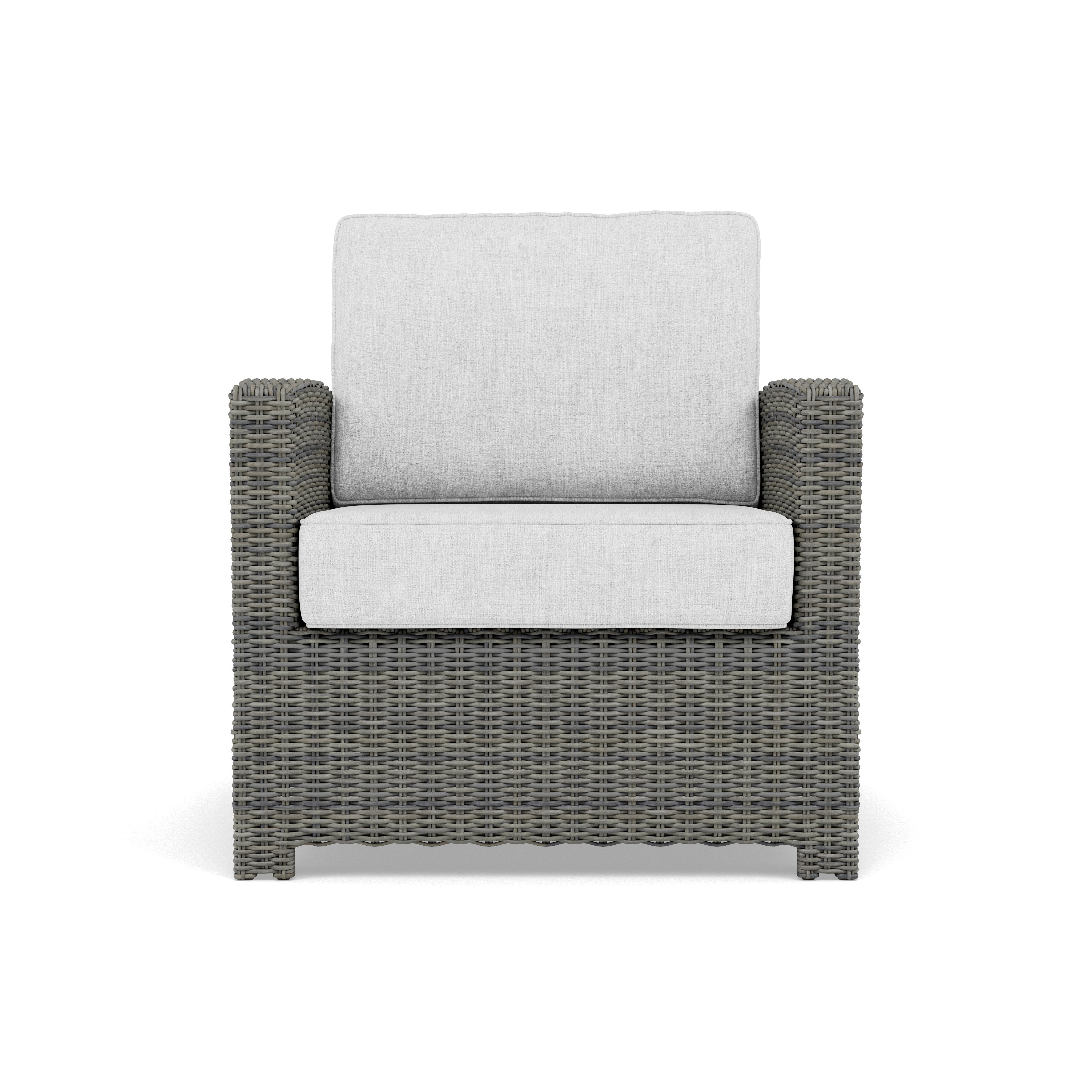 Gray wicker armchair with light gray cushions, viewed from the front.