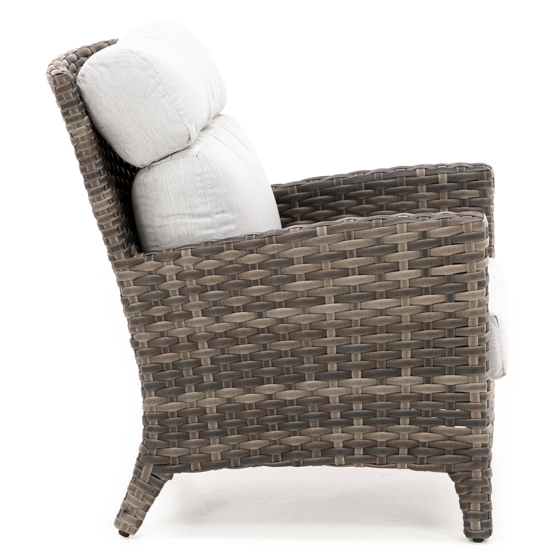 Side view of a wicker armchair with light gray cushions.
