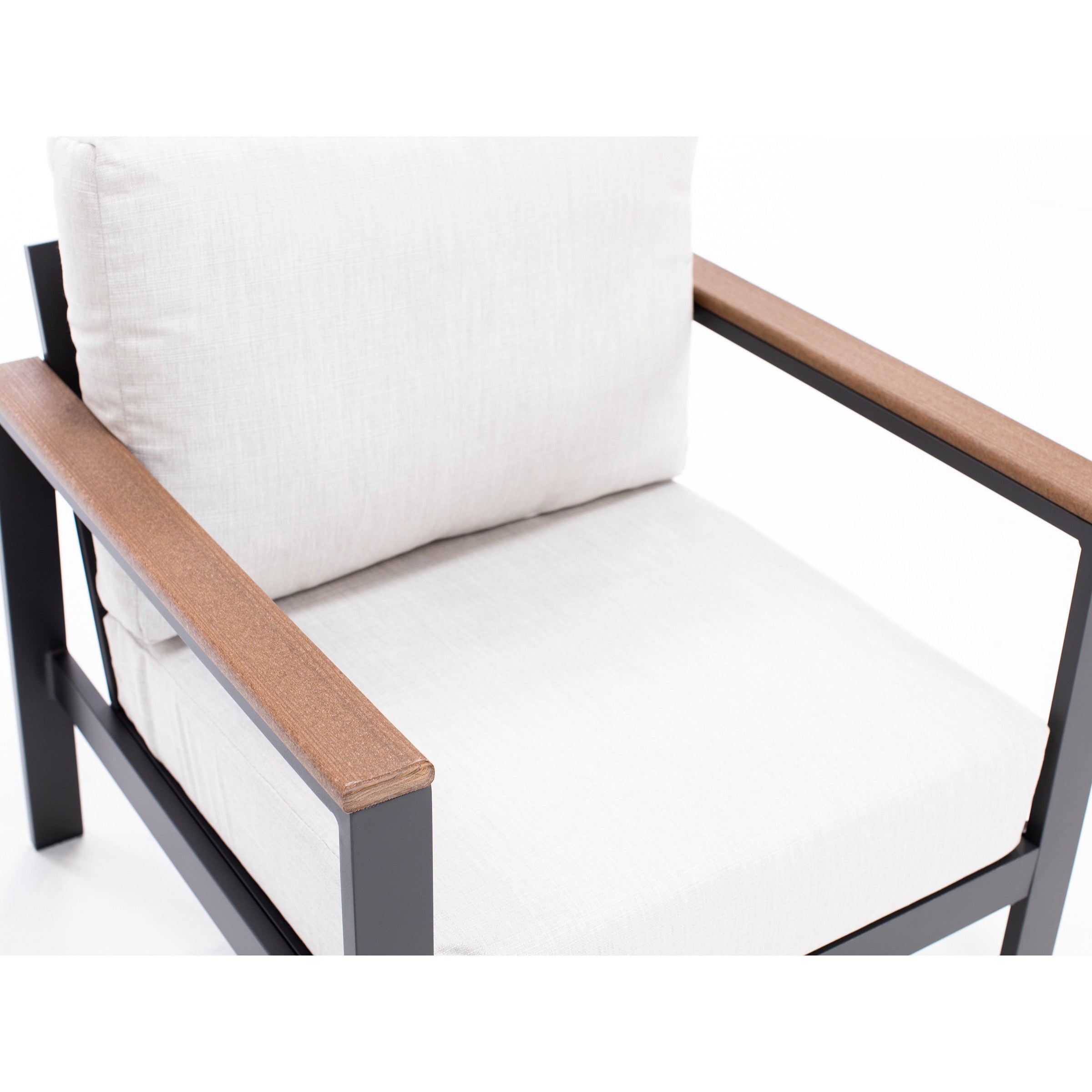 Modern chair with light cushions, black metal frame, and wood armrests.