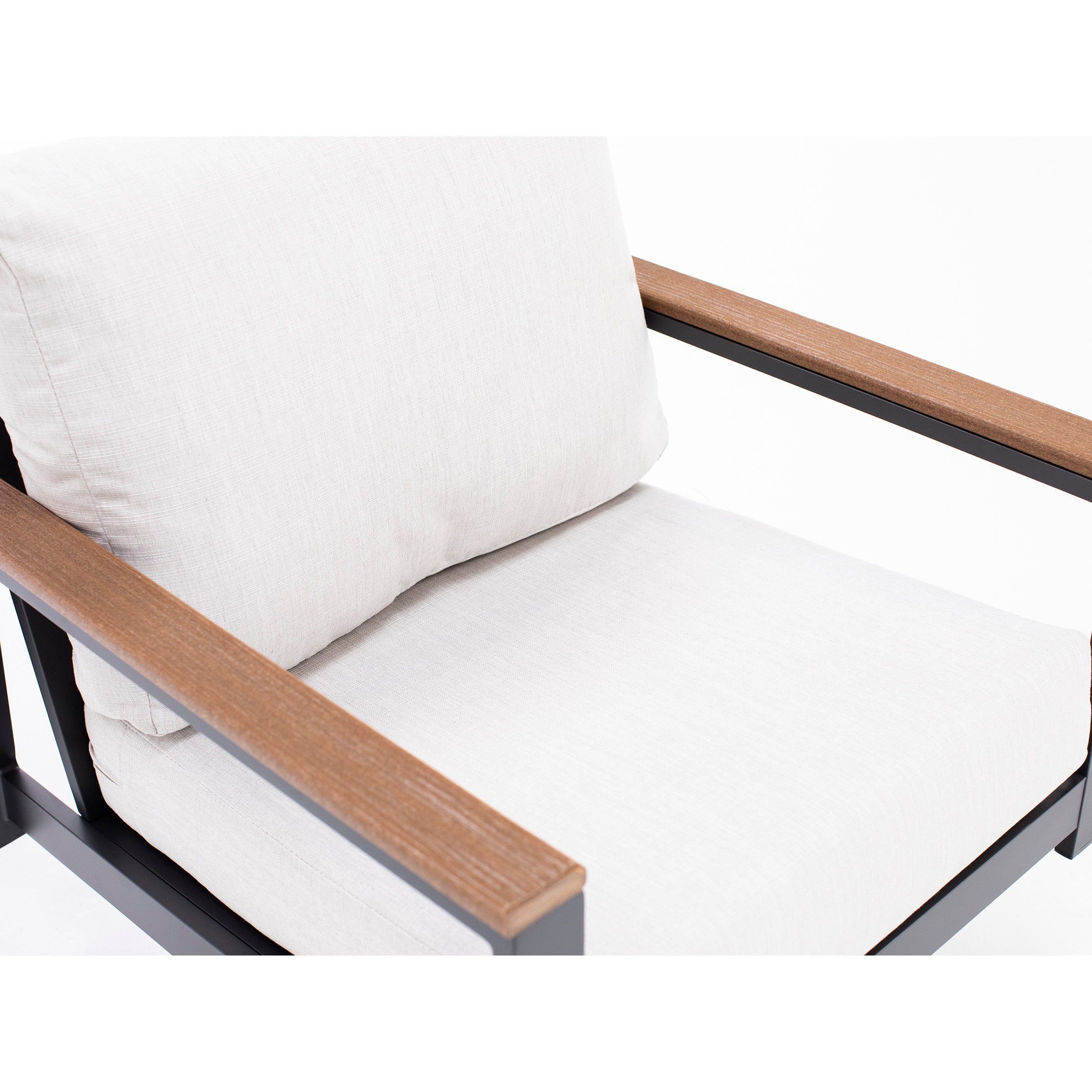 Close-up of a chair with light beige cushions and wooden armrests.