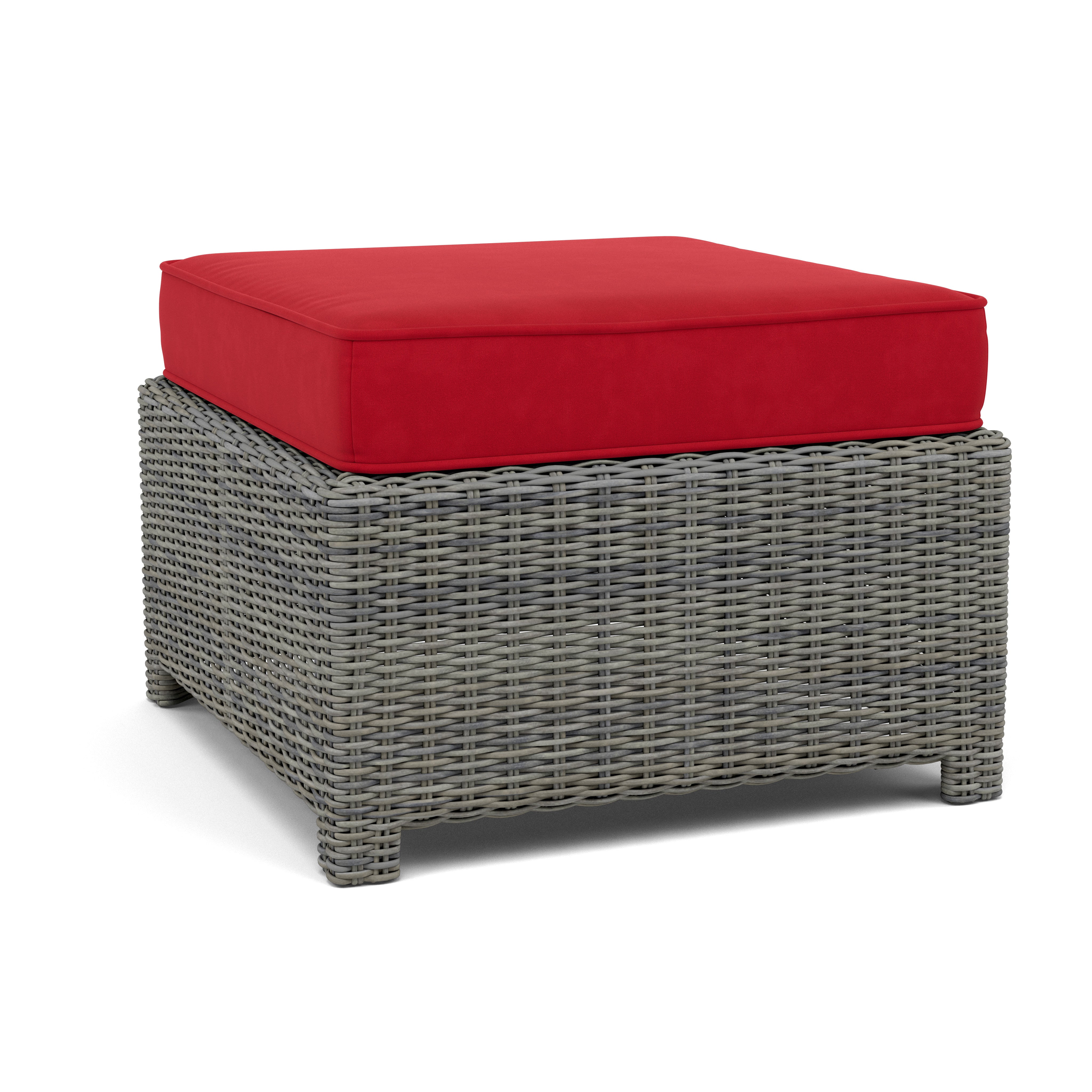 Square woven ottoman with gray wicker base and red cushion.