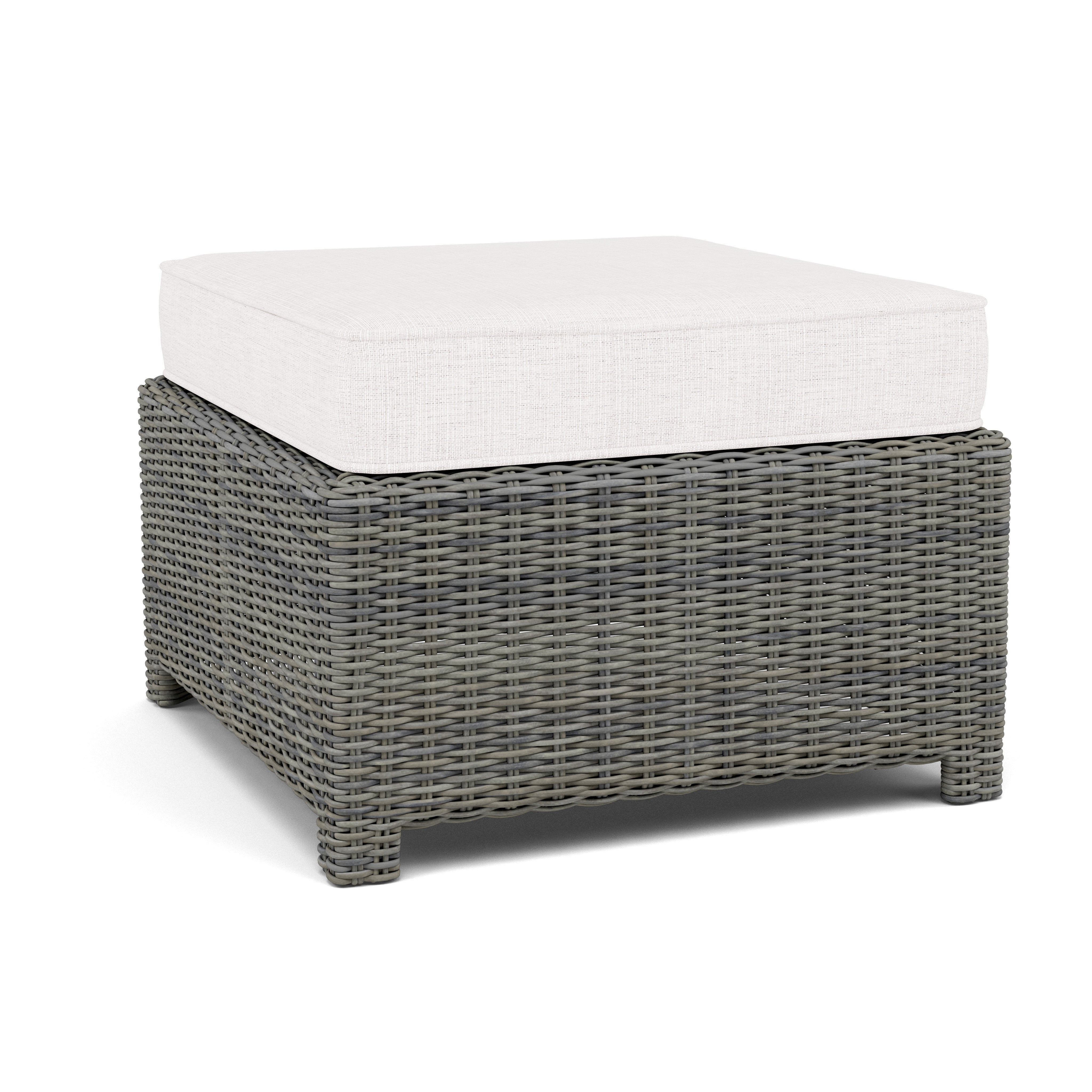 Square gray wicker ottoman with a thick white cushion.