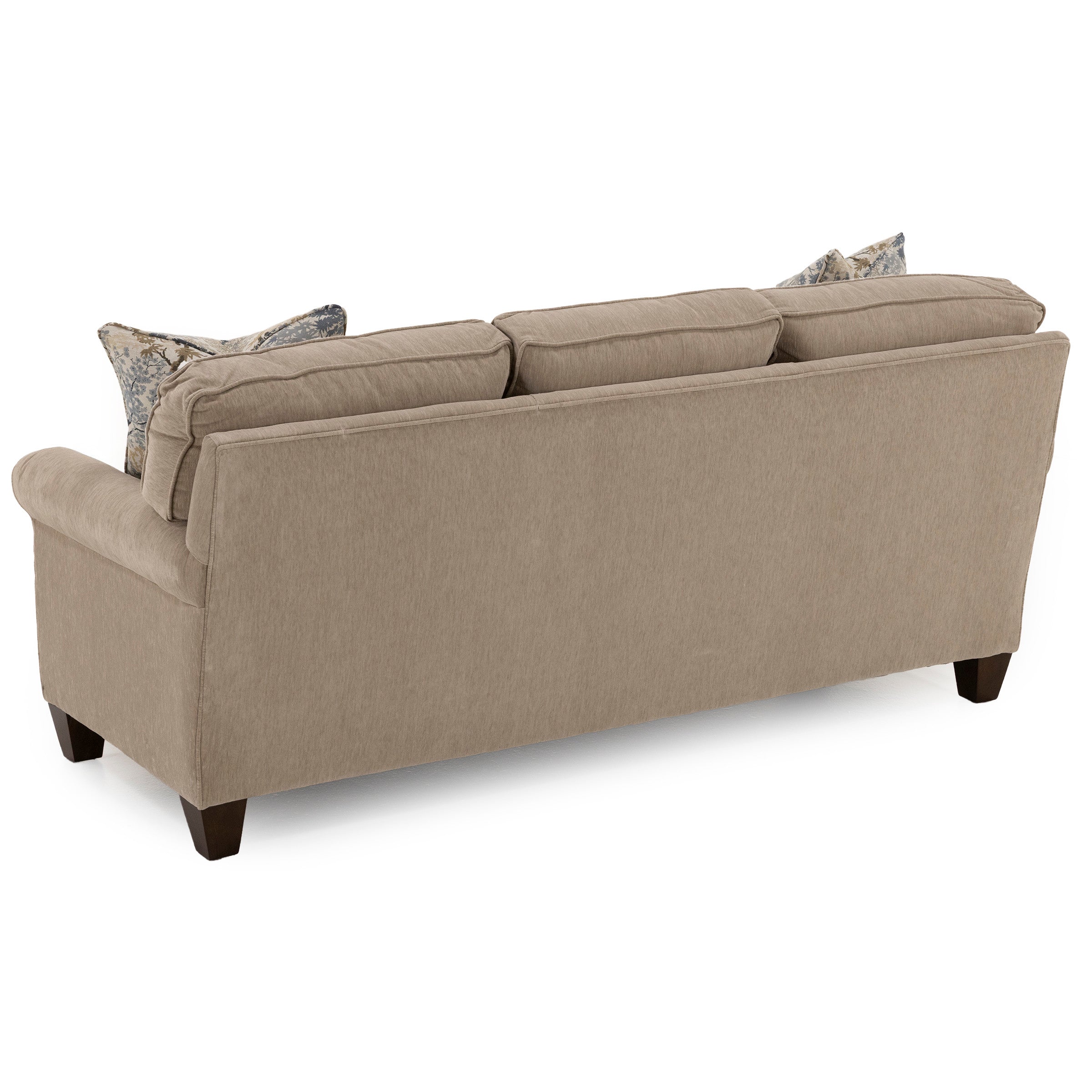 Back view of a beige upholstered sofa with two patterned pillows.