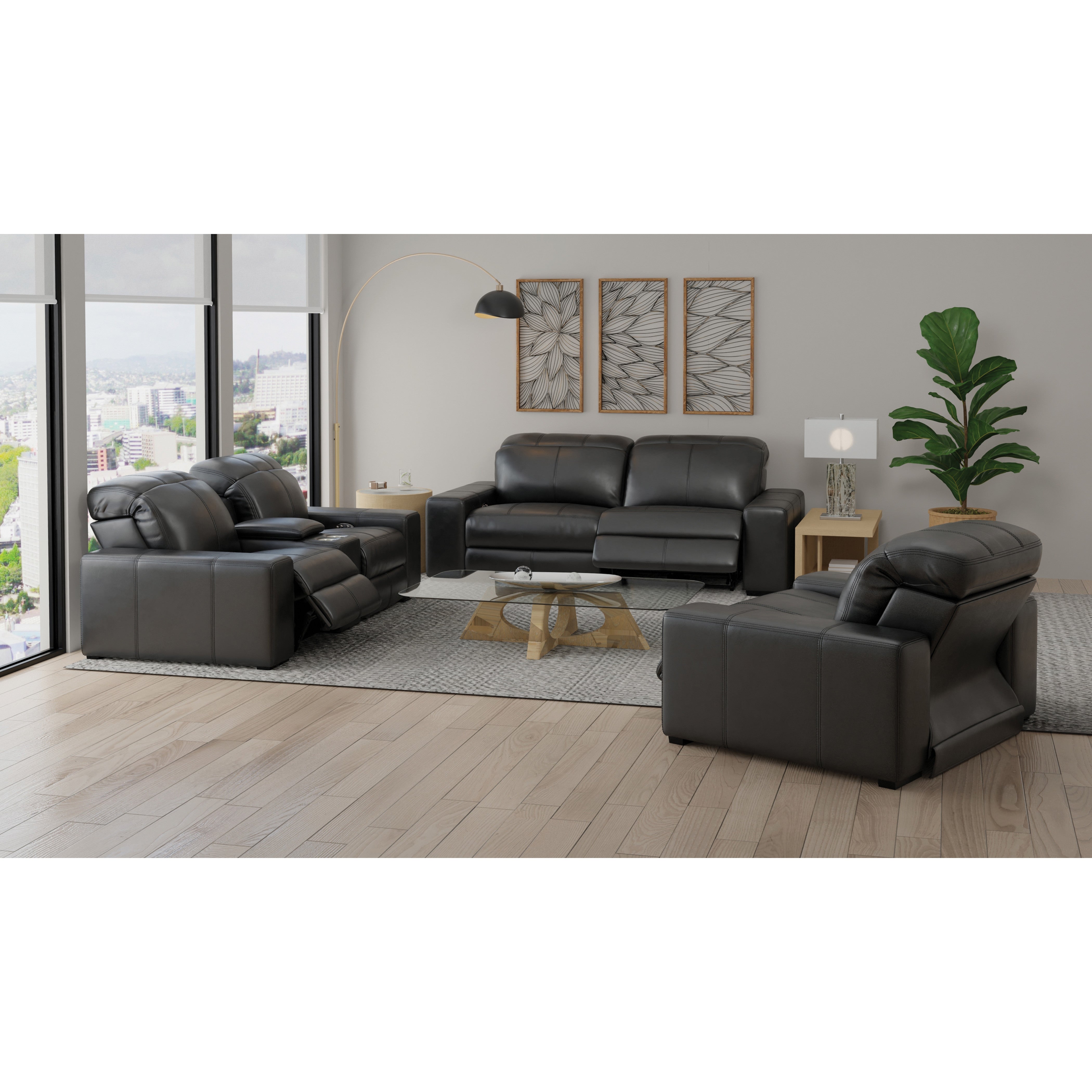 Modern living room with black leather reclining sofas, glass coffee table, and decorative accents.