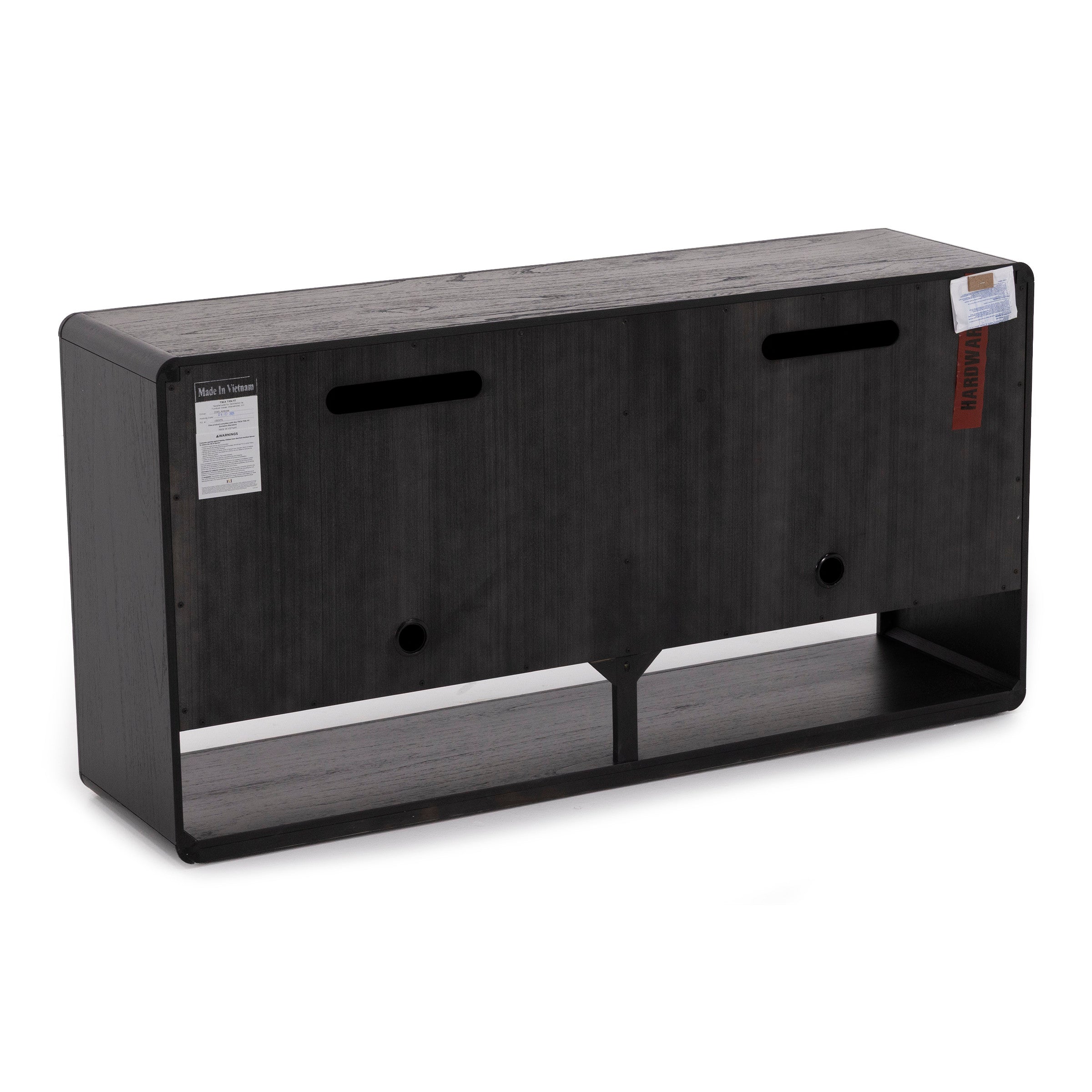 Back view of a black wood media console with cutouts for cables and storage shelf.