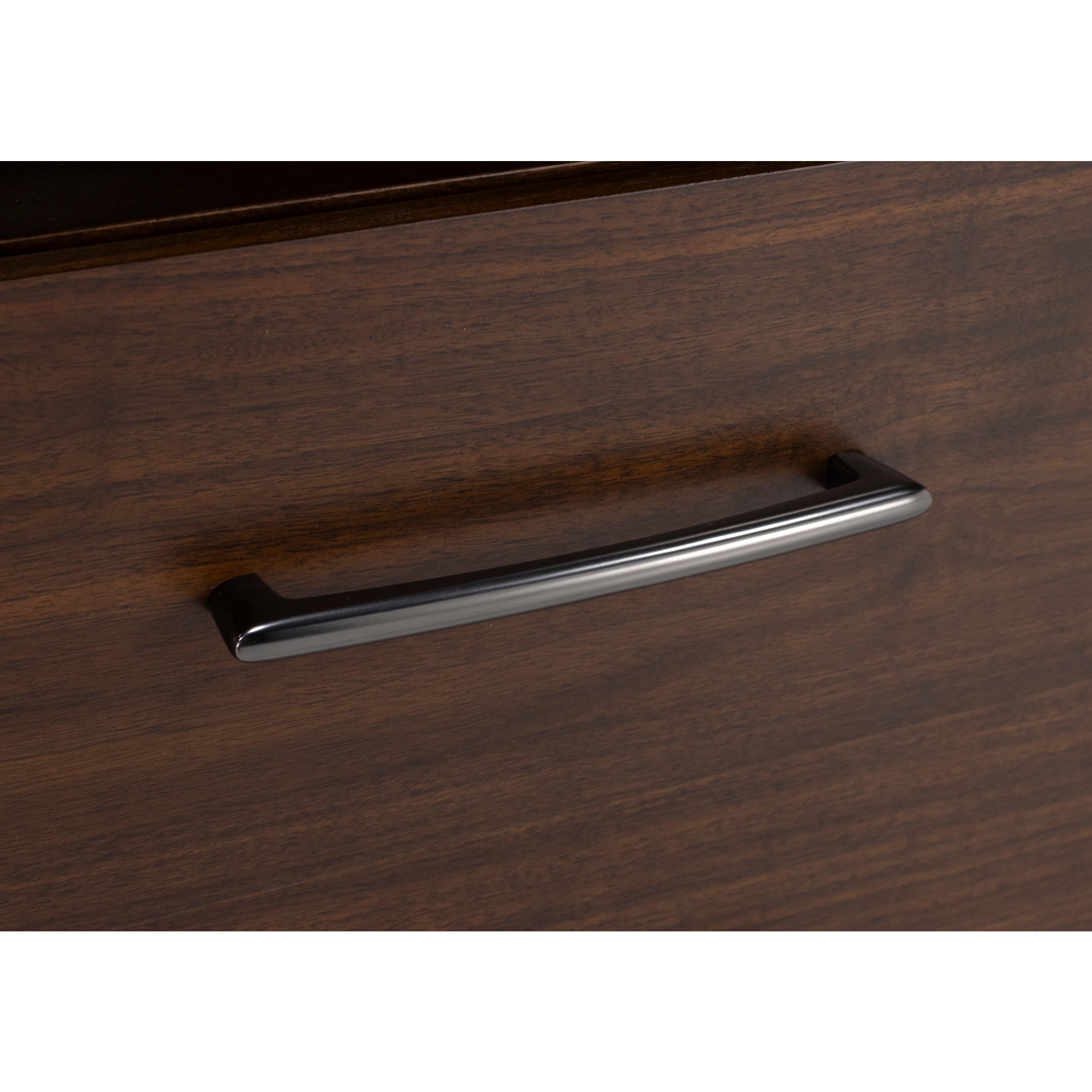 Close-up of a dark metal drawer handle on wood grain surface.
